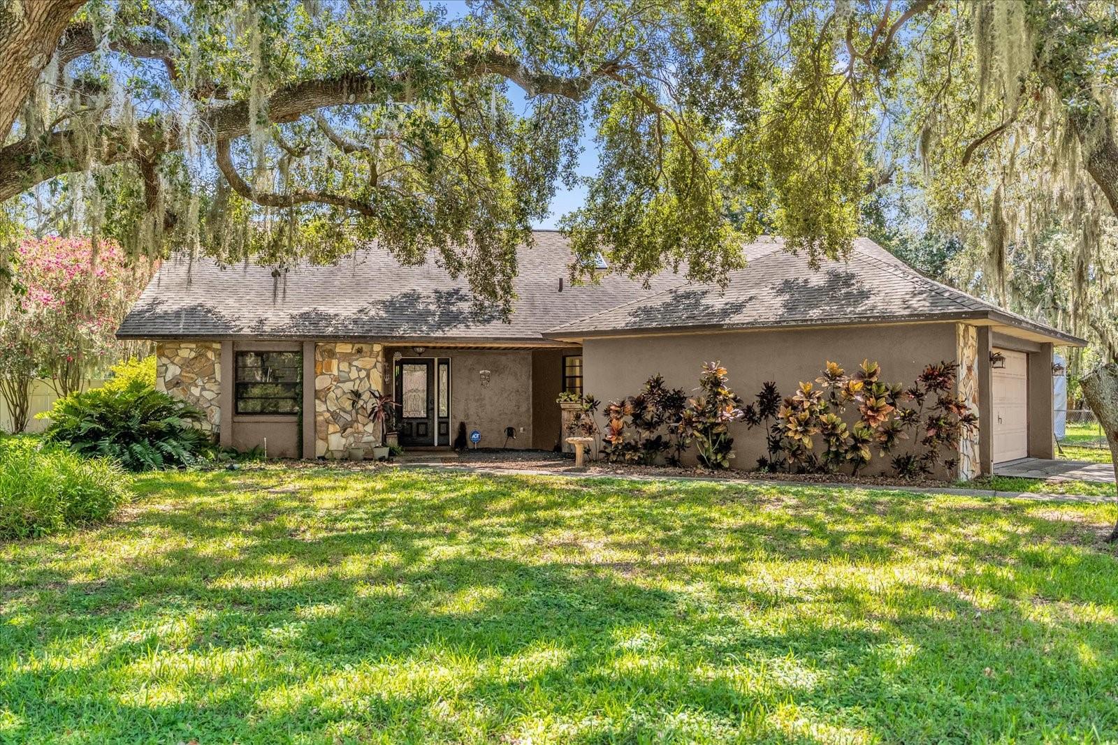 Welcome home! Don’t miss the opportunity to own this one-of-a-kind, 3-bedroom, 2-bathroom, 2-car garage custom home. Upon arriving at the property, you are greeted by an oversized lot and mature trees in a quiet, well-established neighborhood. Inside, the home offers an open and split floor plan, cathedral ceilings, and an indoor/outdoor pool that flows from the back patio into the living room, adding a unique feature to this property—perfect for entertaining and allowing you to take a dip in any weather. On the left side of the home are two spacious bedrooms with large closets and a shared bathroom featuring a single vanity and a shower/tub combo. Moving to the right side of the house, you’ll find the master suite, loft, and kitchen. The master suite offers ample space and direct access to the pool area. The en-suite bathroom includes a garden tub and walk-in shower. The loft overlooks the living room and pool area and also contains two large storage spaces on either side, making storage accessible while serving as a great spot to watch a show and unwind. The kitchen features tile countertops and a small bar for additional seating. Right out back, the pool is enclosed in a full-screen cage with a large deck. The yard also boasts a shed for storage and plenty of space for activities. This home has so much to offer. Don’t wait—schedule your private showing today!