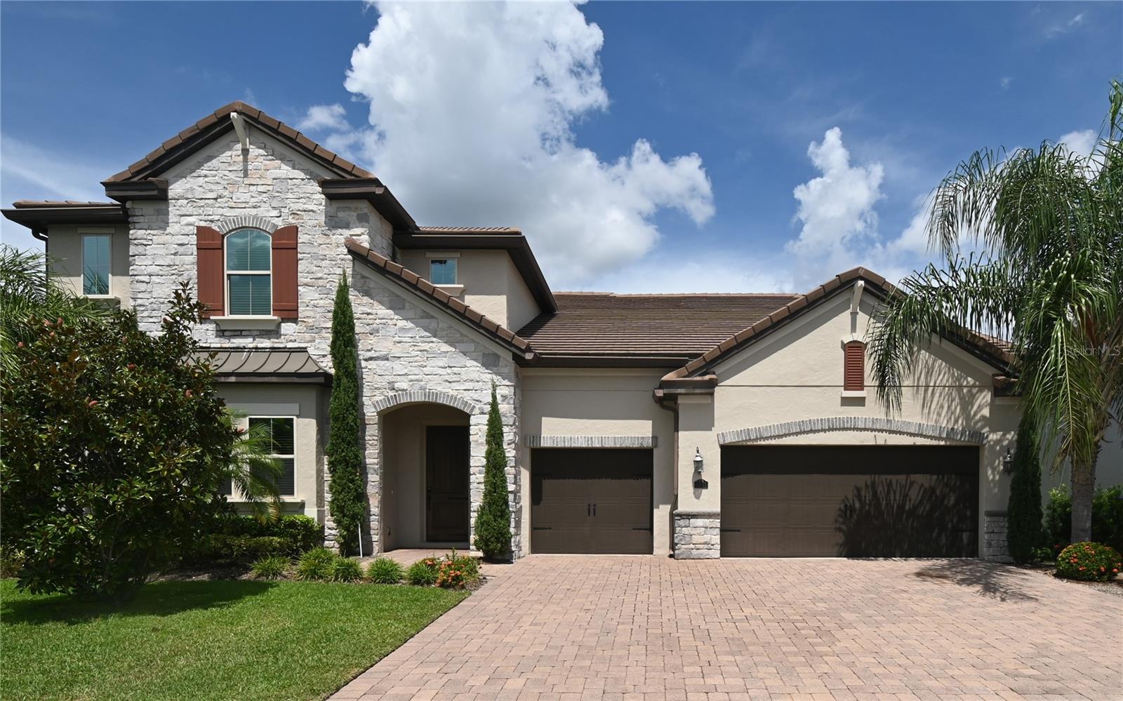 This gorgeous 6-bedroom 4-bathroom home located in the Parkside subdivision is a spacious 2 story home, featuring an open floor plan and FIRST FLOOR master suite! The kitchen features granite countertops, a large island & stainless steel appliances. The home has an oversized family room and dining room combo. The first floor also includes a formal dining room, an office, and a guest room with a private full bath. The primary bedroom is a large with an open concept to the bathroom. The walk-in closet and the closets throughout the home all have custom shelving. On the second floor, you are welcome by an oversized loft area with a wet bar nearby. This area is great for a playroom or another living space. Off the bonus area you have your very own theater room. All remaining bedrooms and bathrooms are on the 2nd floor which are very spacious with great natural light. Two bedrooms share a Jack & Jill bathroom. The one-of-a-kind sliding/folding doors allows you to make your patio and family room one open space which is great for entertaining. The neighborhood has an extra-large clubhouse with community pool and tennis courts.This property is situated in the Dr. Phillips area and just minutes from Sand Lake Road & restaurant row.