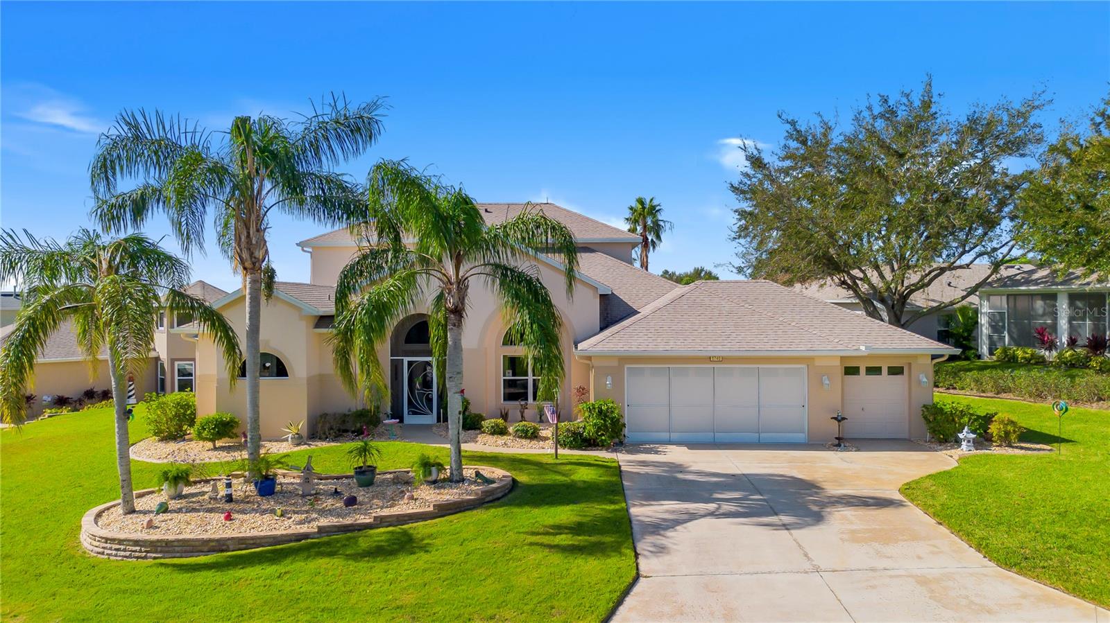 This beautiful home captures the essence of Florida living in beautiful Tavares, the Seaplane Capital. From the moment you arrive, the meticulously landscaped yard welcomes you. Inside, the floor plan offers a living room and dining room combination which is perfect for entertaining. The living room opens to an enclosed lanai inviting you to enjoy indoor-outdoor living at its finest. The split floor plan includes a master suite, with its own access to the lanai and room for a reading nook or office. The master bath features a walk-in shower, double sinks, handicap accessible and a spa-like atmosphere. The upgraded kitchen opens to the family room with a beautiful stone accent wall. Off the family area are two additional bedrooms and a guest bathroom with a solar tube skylight. Upstairs, the fourth bedroom and bonus room provide endless possibilities. With panoramic lake views, the bedroom boasts two closets and a bonus area complete with a wet bar and bathroom. This area can serve as a game room, exercise room, craft room, man cave, or even a guest suite. The AC was replaced in October 2024 with three separate zones. Large driveway with an over-sized two-car garage, golf cart garage and plenty of parking and storage space. Royal Harbor is a gated 55 plus golf cart community offering residents access to a storage area for boats, RVs, and other recreational vehicles. Amenities include an Olympic-size enclosed pool, pickle ball and tennis courts, and a clubhouse featuring a gym, craft rooms, library and a billiards room.