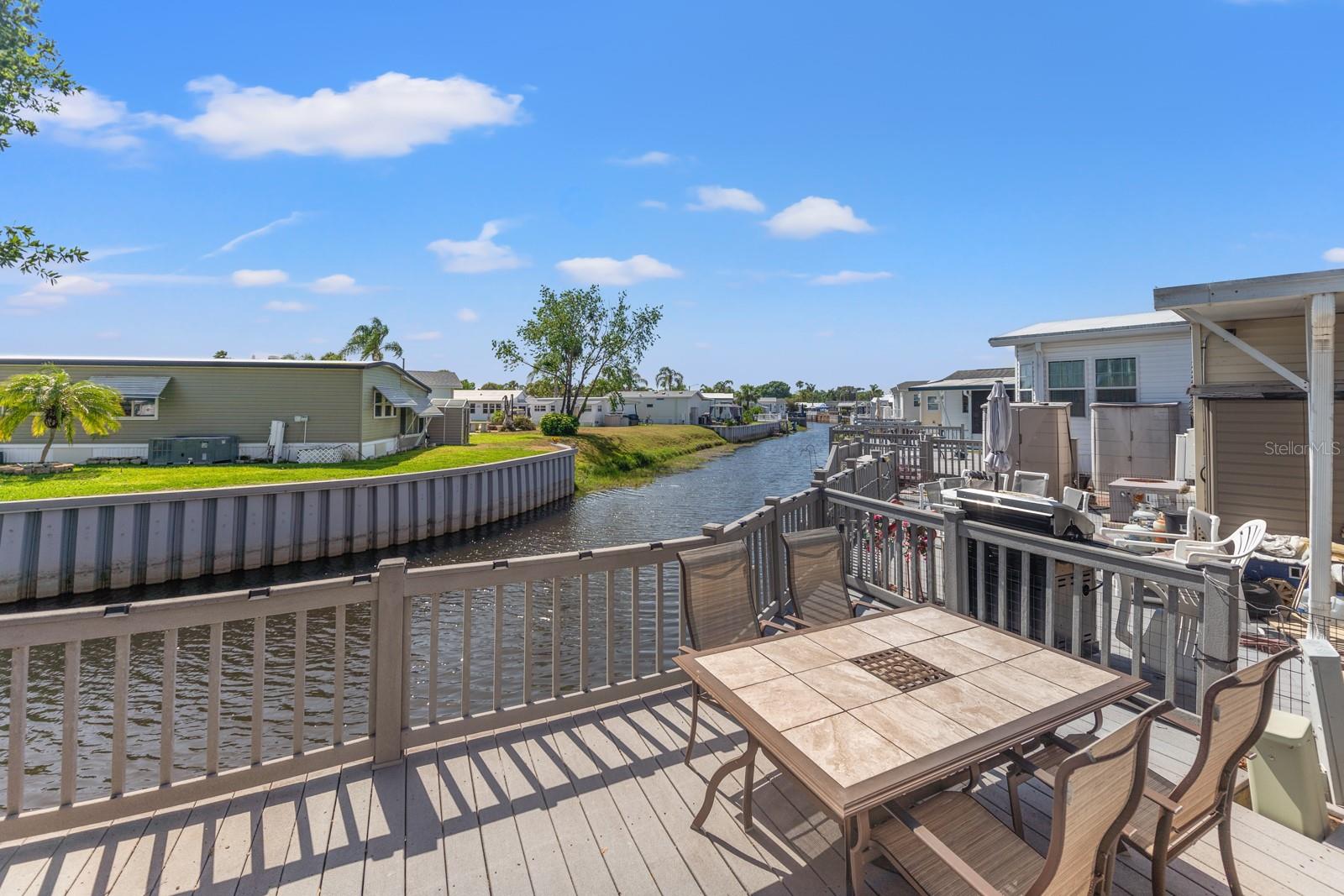 Always wanted to own water front home in Florida but thought it was just a dream?!?! It could be your reality. Pride of ownership shines through as you approach the home. The stunning driveway welcomes you to this beautiful home with front awning, patio and elevated covered balcony. This beautiful, well maintained 2 bedroom home is calling your name! Enjoy the tranquility of this canal location which leads to 175 acre Lake Davenport. This home boasts a good sized deck overlooking canal as well as screen room attached to the back of the home. This low maintenance home is packed with tasteful updates including laminate flooring in all but the bathrooms which are laminate vinyl. The kitchen has undergone some modification with new base cabinets, counter tops and decorating planks along the breakfast area. Lots of storage in the master bedroom, The second bedroom currently doubles as an office but has a futon which opens to provide sleeping accommodation for guests. This second bedroom has a half bath and laundry closet with full sized washer & dryer. The roof was replaced in 2024. This partially furnished home will suit the most discerning buyer. From the guard gated entrance to the clubhouse and amenities overlooking Lake Davenport, this community has something for everyone. tennis courts, two community pools, mini golf, etc. as well as different activities & social events for you to enjoy. Outdoor Resorts even has a beach with views of Lake Davenport. Time to enjoy the Florida lifestyle.