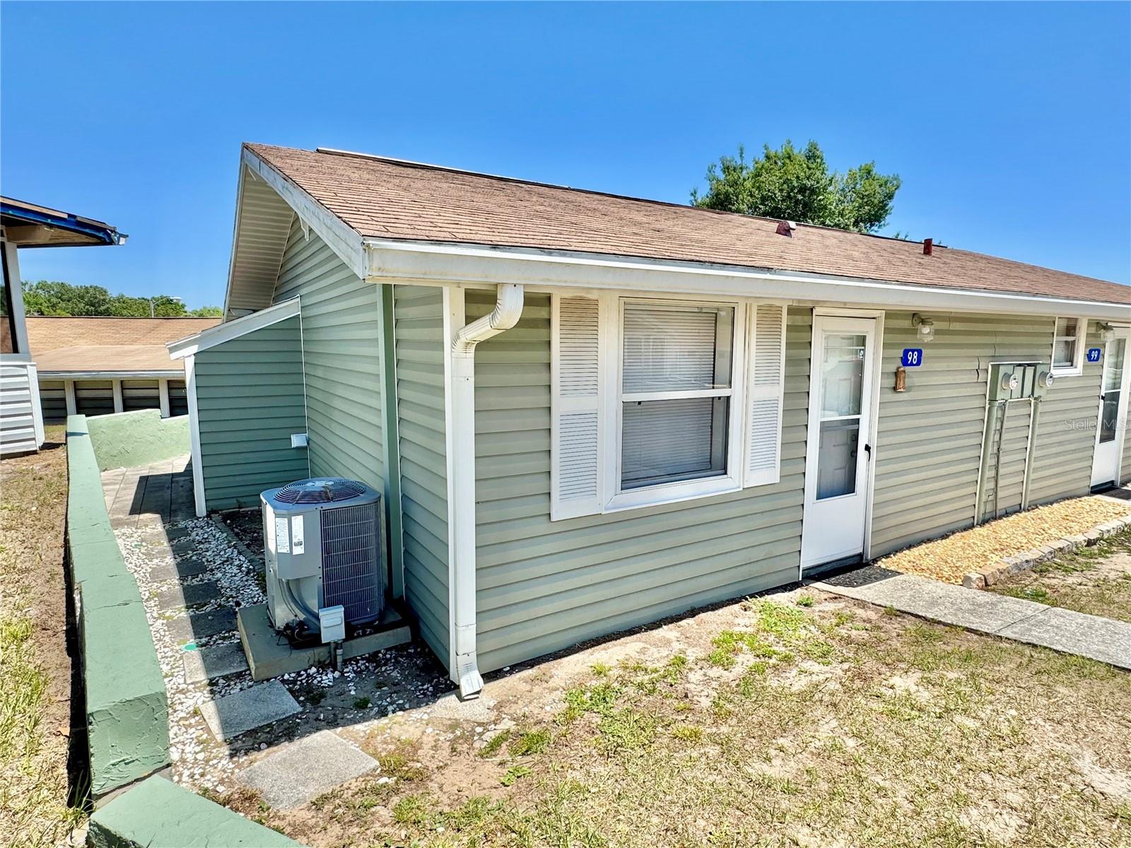 RENOVATED VACATION VILLAGE 'VILLA' UNIT is now available for purchase. These nice updated units are not available often. This vacation home has many updates like newer sliding glass door, windows, front door, and a beautiful remodeled kitchen. Screened in rear porch is a great place to relax and take in the fresh air. You can walk down to one of the many community amenities. It always feels like you're on vacation everyday here and it feels like home too as it’s super clean & comfy inside. Not only does this community have an Olympic size swimming pool, tennis/pickleball courts, basketball courts, car washing station, multiple playground areas it has CLERMONT CHAIN OF LAKES PRIVATE BEACH access via the community LAKEFRONT lot just for Vacation Village, private community BOAT RAMP, Dock and even fenced in oversized parking lot area for RVs, vehicles and boats. Live here full time or part time, you can rent the unit long term or short term, you can even have the front office property managers handle the rental bookings for you and just send you the $$$$. Monthly HOA fees include exterior of structure such as the siding, roof, lawn, cable, WiFi, water, sewer, trash and common area amenities. You are minutes from anything you could possibly need from groceries, shopping, medical care, entertainment and dining. Orlando International Airport, Universal Studios and Walt Disney World® are less than 30mins away and the salty air/water/sand is 90mins away to many World Famous Beaches like Daytona Beach. What more could you ask for? Book your private tour and snag this one up fast!
