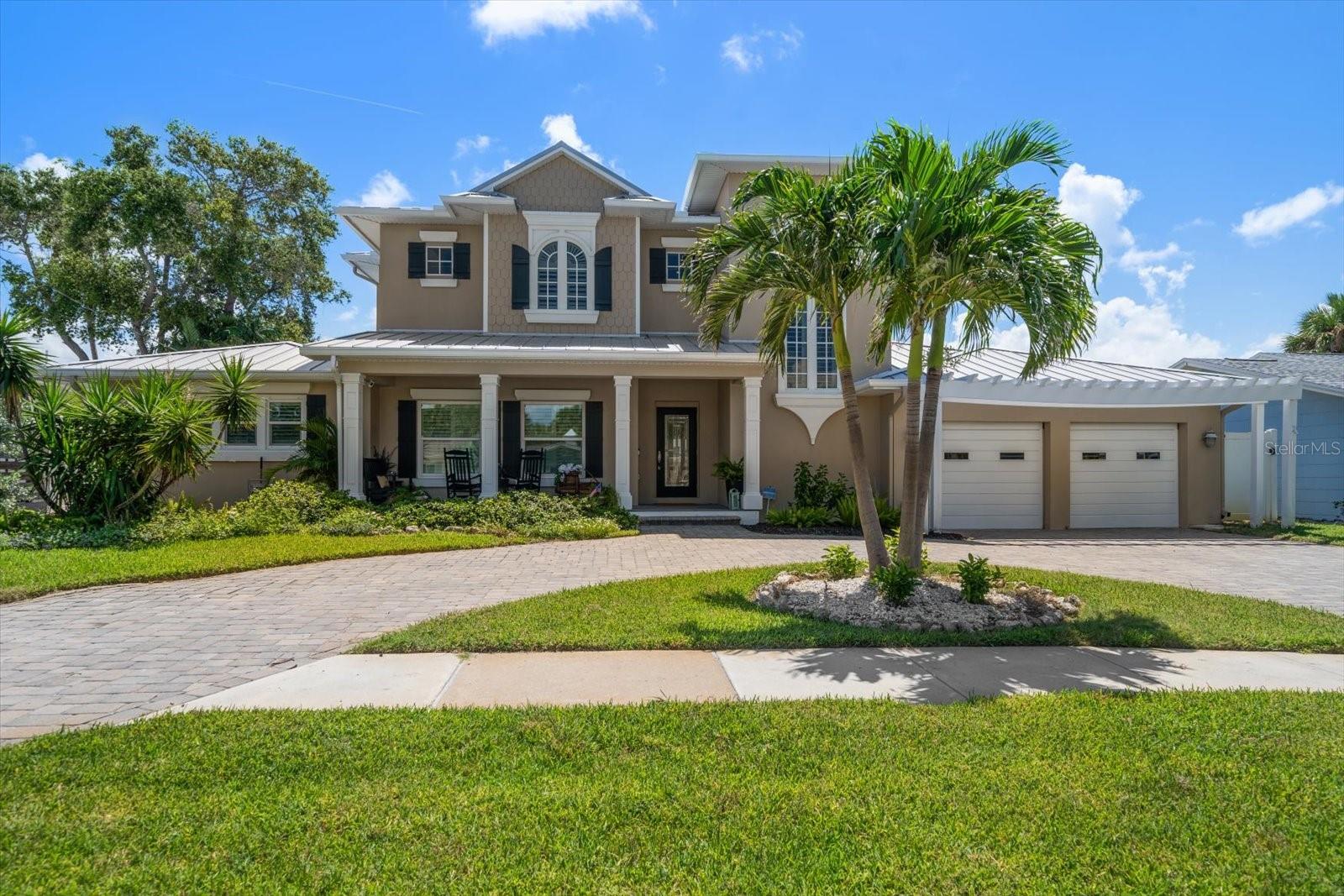 Experience the ultimate coastal lifestyle in this beautifully renovated home on the desirable North End of Clearwater Beach, where every detail evokes the essence of relaxed seaside living. A pavered circular driveway and welcoming front porch set the stage for this bright, open retreat, ideal as a full-time residence or beach getaway. Inside, the home unfolds in a seamless blend of warm coastal tones and wood-look ceramic tile floors, leading to a spacious family room where sliders open to a versatile sunroom offering endless Intracoastal views. The recently renovated kitchen is a standout with stainless steel appliances, quartz countertops, a custom pantry, and water views. A glass door leads to a backyard paradise, making entertaining easy and effortless, perfect for gatherings after a day on the water. Downstairs, three well-appointed bedrooms provide comfort and privacy, including one with an ensuite bath. Upstairs, the primary suite is a private sanctuary, complete with a reading loft, custom built-ins, space for a home office, a huge walk-in closet, electric blinds, and panoramic water views from bed. Step out onto your private balcony or retreat to the luxurious ensuite bath with tub and walk-in shower. Outside, enjoy multiple entertaining areas, ideal for soaking in tropical breezes, spotting dolphins and manatees, or launching a kayak or paddleboard and exploring the mangroves. A true boater’s paradise, and just a short walk to the beach, local restaurants, and shops. Recent upgrades include new HVAC and all-new electric downstairs. Move-in ready and waiting—don’t miss your chance to live the Clearwater Beach dream!