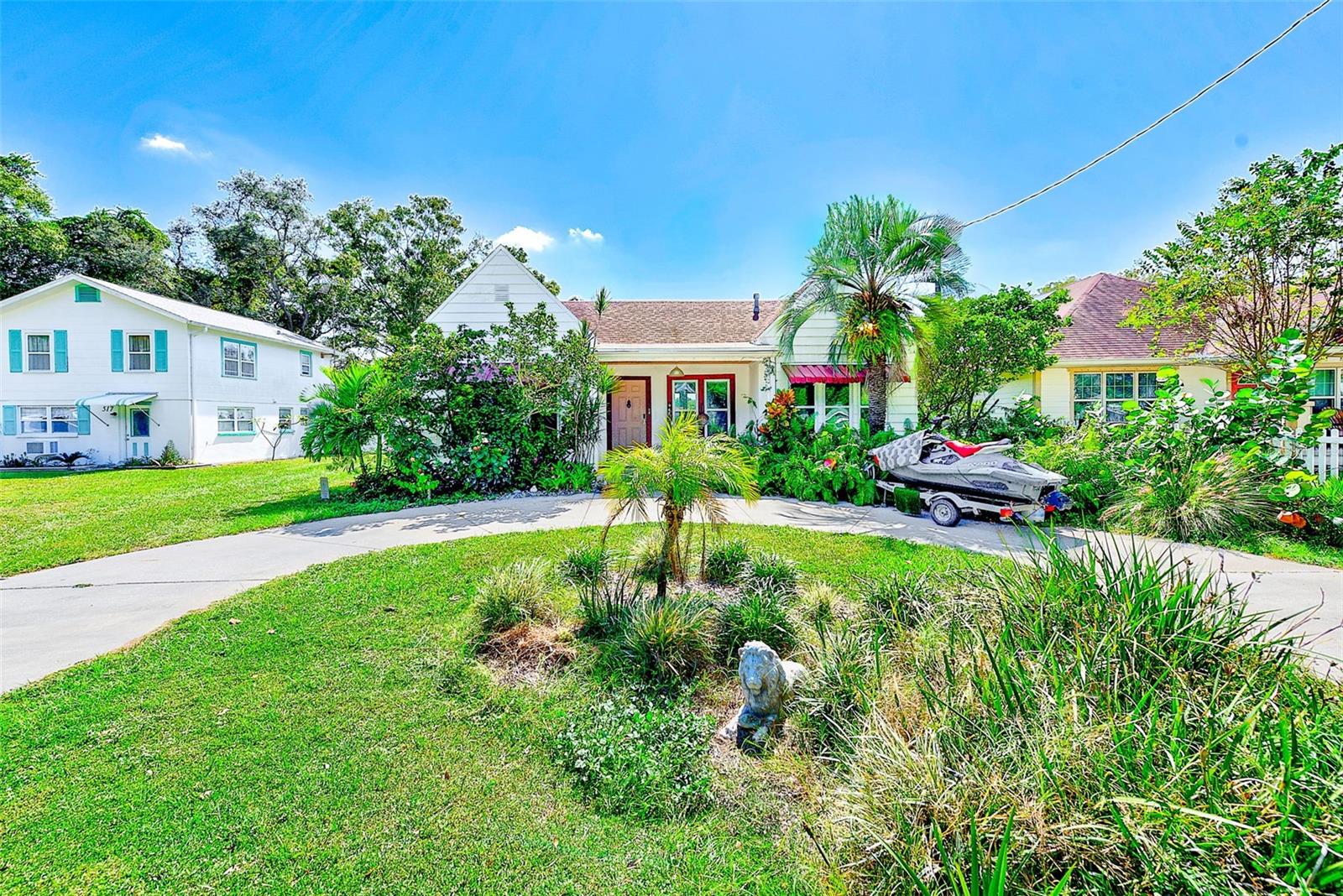 Step into Old Florida charm with this delightful 1925 bungalow that seamlessly blends historic character with modern conveniences. This two-bedroom, two-bathroom home showcases original architectural details including authentic doorknobs, doors, and soaring nine-foot ceilings that transport you back to the roaring twenties. The interior features tile and wood floors throughout, creating warmth and elegance in every room. You'll discover both a formal dining room and an eat-in kitchen space, perfect for everything from intimate meals to entertaining guests. The thoughtful 2015 renovation added a second bathroom while preserving the home's authentic charm, along with new air conditioning, updated ductwork, kitchen cabinets, and windows. The outdoor space truly shines with abundant room for entertaining, complete with potential for a fire pit area and gatherings under Florida's beautiful skies. The circular driveway adds both convenience and classic appeal to the property's curb presence. Located in the heart of Largo and situated in a non-flood zone, this home offers the perfect balance of historic charm and practical living. You're just minutes away from pristine Gulf beaches, the vibrant Largo Cultural Center, and convenient shopping destinations. Whether you choose to embrace innovative modern updates or preserve the timeless Old Florida character, this bungalow presents endless possibilities. The solid 1920s craftsmanship provides an exceptional foundation for creating your dream home in this desirable Largo location.
