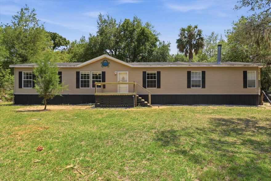 This spacious 4-bedroom, 2-bath manufactured home offers privacy and room to roam, being situation on 1.15 acres. The home features an open-concept layout with a large living area with laminate flooring, a bright kitchen with abundant cabinetry and a center island, and a comfortable primary suite with dual sinks, a soaking tub, and separate shower. Want more room to spend time relaxing or entertaining? The huge formal living room can be transformed into a game room, office, or just about anything your heart desires. The expansive back yard offers all the room you need to store your boats, trailers, RVs, and outdoor equipment with ease and provides endless opportunities for entertaining—set up a fire pit, host gatherings, add a garden, or create the outdoor oasis you’ve always imagined. With plenty of open space and mature natural surroundings, this property is  for anyone who values privacy, flexibility, and the freedom to enjoy the outdoors, yet within easy reach of town amenities. Enjoy peaceful mornings and evenings on the expansive covered back porch overlooking your wooded surroundings. Call today for your own personal tour.