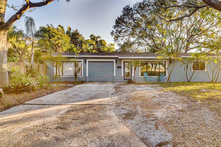 Welcome to this tastefully modernized 3-bedroom, 2-bath, 1,500 square foot home nestled on a quiet, tree-lined street in the heart of the coveted Jungle Terrace neighborhood. Perfectly positioned just 10–15 minutes from the Gulf beaches and vibrant Downtown St. Petersburg, this home offers the best of both worlds — peaceful Old Florida charm with close proximity to endless shopping, dining, entertainment, and everything the Tyrone area has to offer. Designed with entertaining in mind, this home showcases an expansive open kitchen featuring contemporary cabinetry, large white quartz countertops, a wraparound island perfect for gathering, and newer stainless steel appliances. Modern lighting and plumbing fixtures, fresh interior and exterior paint, newer flooring throughout, and ornate contemporary trim work around windows and columns help elevate the home’s clean and stylish feel. The split floor plan offers privacy and functionality, highlighted by an expansive primary suite complete with ample closet space and a large bathroom featuring a glass-enclosed shower, contemporary tile designs, and plenty of room to operate. The hall bathroom also features modern tile work and an updated vanity.
Step outside into your peaceful, fully fenced backyard retreat designed for relaxation and hosting alike. Enjoy grilling on the deck and patio area, unwind in the 8-person hot tub after a day at the beach, or relax in the bonus sunroom with wraparound windows — the perfect spot for morning coffee and a good book. A double driveway provides ample parking for guests, while the one-car garage offers additional storage space. Additional highlights include a 2025 roof, newer AC system, interior laundry room, and a layout that truly embraces the Florida lifestyle. Bring your family, friends, and pets — this Jungle Terrace gem is ready to impress. Buyer to verify public records for square footage, permitting, and home details. Furniture included with full price offer.