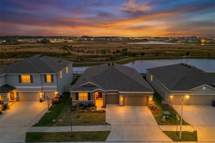 One of the best lots you’ll find in Epperson. This Camden floor plan backs up to a massive preserve with peaceful water views, creating a level of privacy and natural scenery that’s hard to come by in the neighborhood. The home also features a true multigenerational suite and a three-car garage, two features that immediately set it apart.

Just inside the front door, you’ll see this home has been elevated well beyond the standard builder finishes, with tasteful upgrades and thoughtful design details throughout. Off the entry are two secondary bedrooms connected by a Jack-and-Jill bathroom, creating a comfortable private wing for family or guests.

Moving further into the home, the layout opens into a spacious great room that immediately draws your eye to the preserve views behind the property. A tray ceiling, custom fireplace, and designer touches give the space a warm and polished feel, while the size of the room easily accommodates a full dining area within the main living space.

The kitchen sits just off the great room and is loaded with upgrades, including white cabinetry, a massive granite island, gold hardware, and designer lighting. A breakfast nook sits alongside the kitchen and continues to capture the beautiful preserve and water views.

The primary suite is tucked just beyond the main living area and continues the theme of peaceful scenery and thoughtful design. Tray ceilings add architectural character, while the spacious en suite bath includes a garden tub, walk-in shower, double vanities, and a large walk-in closet.

What truly sets this home apart is the multigenerational suite. Designed as a flexible private living space, it includes its own living area with tray ceiling and recessed lighting, a kitchenette with sink, cabinetry, and refrigerator, plus a private bedroom with its own en suite bath. Whether used for extended family, long-term guests, or even as a media room or hobby space, it offers a level of flexibility that’s hard to match.

Out back, the screened-in lanai is the perfect place to relax and take in the preserve setting. With wide open green space and water views behind the home, the backyard offers a peaceful backdrop that most homes in the community simply don’t have.

Beyond the home itself, living in Epperson means enjoying one of Wesley Chapel’s most well-known lifestyle communities. Residents have access to the 7.5-acre Crystal Lagoon, where you can relax on sandy beaches, enjoy water activities, or take part in community events throughout the year. Additional amenities include playgrounds, a dog park, butterfly garden, and miles of paths perfect for biking, jogging, or simply taking a golf cart ride through the community. UltraFi high-speed internet is also included throughout the neighborhood, making it easy to stay connected whether working from home or streaming your favorite shows.