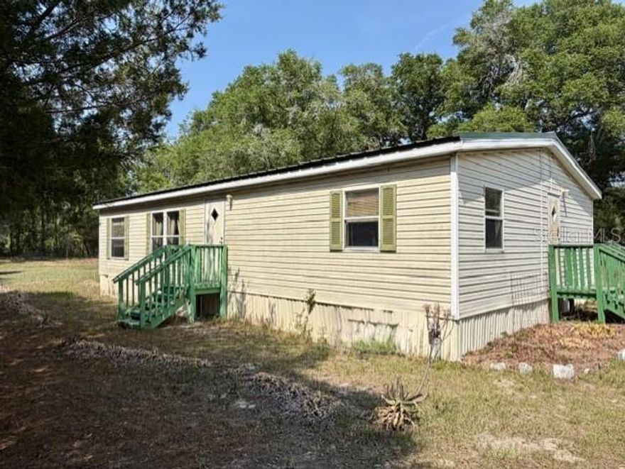 Bring your animals and embrace the farm life on this 19.5-acre, fully fenced and cross-fenced property in the heart of Bell, Florida. Designed with functionality in mind, this versatile acreage is ideal for livestock, horses, or establishing your own working farm or homestead. The property features a 3-bedroom, 2-bath manufactured home with 1,188 heated and cooled square feet and a durable metal roof—providing a comfortable base while you build out your agricultural vision. A two-car carport offers convenient covered parking, and a recently added livestock shelter (only five months old) in the field provides protection and comfort for your animals. This property is well-equipped with two 140-foot-deep wells and two separate electric services—one at the front of the property serving the home, and a second at the rear paired with the additional well—offering flexibility for expansion, additional structures, or agricultural use. A Generac whole-house generator ensures you’re prepared year-round, while a six-zone irrigation system services the front portion of the property, making it well-suited for gardening, crops, or maintaining lush pasture. The 16x20 greenhouse is perfect for starting plants, growing your own produce, or supporting a self-sustaining lifestyle. Adding even more value, a 54-inch cut riding lawn mower, air compressor, and watering and feed troughs will be included—making this property even more turnkey for your farm or homestead needs. With established fencing, usable land, and essential infrastructure already in place, this property is ready for cattle, horses, goats, or other livestock. Whether you’re looking for a private country retreat, a mini-farm, or a full-time agricultural operation, this North Florida property offers the space, setup, and freedom to make it your own. Ideally located just minutes from Rock Bluff Springs and the scenic Suwannee River, you’ll enjoy easy access to some of the area’s best natural attractions for boating, kayaking, and outdoor recreation. Enjoy wide-open spaces, peaceful surroundings, and true rural living—just a short drive from local amenities.