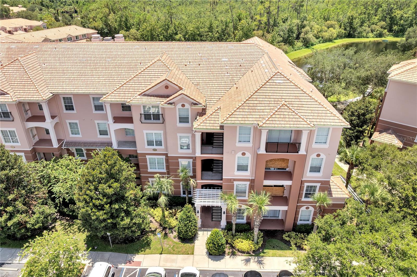 Welcome to Bella Trae luxury living in Champions Gate! This spacious 3-bedroom, 2-bath Sonoma floorplan (approx. 1,248 sq ft) offers resort-style amenities with unbeatable convenience. Effortless Florida living with open concept living and dining areas, perfect for entertaining or relaxing. Meal prep made easy in the kitchen featuring 42" wood cabinets, ample counter space, and included appliances. A split-plan layout ensures optimal privacy with two guest bedrooms and a serene primary suite. Enjoy your morning coffee or evening breeze on the screened lanai overlooking water views or preserved greenery. One assigned covered carport with storage closet, 2 elevator access, and in-unit laundry add daily convenience. Included in HOA monthly fee: water, basic cable, internet, pest control, exterior maintenance, building insurance—and more, ensuring worry-free living. Enjoy an array of world-class amenities: 12,000 sq ft clubhouse with fitness center, media room, billiards/game room, putting green, zero-entry pool & spa, tennis courts, and a full-time activities director. Ideally located minutes from I-4, Champions Gate shopping and dining, and the theme park corridor—Disney, Universal, top golf courses, and entertainment are within easy reach. Note home includes: small TV in guest bedroom, large living room TV, water filter system near water heater, dining table with 6 chairs, living room console. Property has: new lanai are being renovated and screened in, new roof, carpet are 3 yrs old, dryer lint system cleaned out professionally annually, AC system serviced bi-annually. Move-in ready home and semi-furnished.