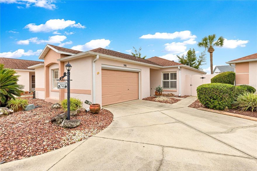 ONE-OF-A-KIND VILLA – BOND PAID!
Located in the Village of Rio Grande, this 2-bedroom, 2-bath courtyard villa offers exceptional flexibility for working from home, pursuing hobbies, or simply enjoying expanded outdoor living space.
Part of the garage has been professionally converted into a beautiful air-conditioned OFFICE featuring custom built-ins, desks, closets, INSIDE LAUNDRY, and a matching refrigerator—ideal for today’s lifestyle needs.
Inside, you’ll find vaulted ceilings, Solar tubes, window treatments, a granite kitchen with updated cabinetry and pull-outs, CONTINUOUS 18” TILE flooring, and new luxury vinyl plank (LVP)in the hallway and bedrooms. The dining area opens to a COVERED OVERSIZED AWNING —perfect as a library or reading space—leads directly to an expansive, TILED, and very private COVERED LANAI.
Additional enhancements include:
• Solar panels (last electric bill approx. $38)
• Whole-house generator
• Plantation shutters
• Designer fans
• New side gate
• Giant covered lanai
• Granite & stainless-steel appliances
• Oversized living space
• Inside laundry
• Vintage Cadillac-style replica golf cart with newer batteries
This home is ideally positioned just a quick walk to the De La Mesa private community park and pool, featuring a walking trail, saltwater heated pool, and bath facilities. It’s also located a short walk or ride to Spanish Springs, and a little over 2 miles from Lake Sumter Landing, with easy access to recreation centers, medical, shopping, and a wide array of dining options.
A home that truly captures the feel of Florida living. Schedule your private showing today.