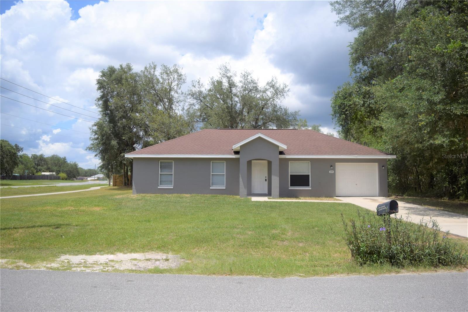 This charming renovated corner lot home is move-in ready and conveniently located near Lake Weir High and Lockheed Martin. Home features a 3 bedrooms, 2 baths, one car garage, open floor plan with vaulted ceilings, living/dining area, kitchen with breakfast bar and inside laundry room. Home has been freshly painted ( inside and out), new laminate wood floors throughout the home and newer appliances. Pet Restrictions applied.