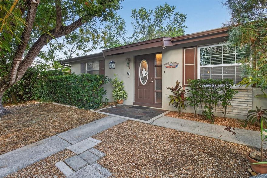 Step into this truly one-of-a-kind 2-bedroom, 1-bath home blends character, comfort, and tropical charm!  From the moment you arrive, you’ll fall in love with the lush tropical landscaping and unique curb appeal that make this home stand out. Enjoy mornings or evenings on the oversized screened-in porch, with walkable corrugated ceiling and custom wood details is a true standout and includes a custom-built table that perfectly compliments the natural wood beams and outdoor setting. Inside, you’ll find a spacious layout that includes, a family room complete with a fireplace, perfect for relaxing or staying warm on chilly nights.  Stonework accents inside the kitchen, doorways and window add to its unique appeal. The eat-in kitchen area has built in tiled shelves with room for a small table and chairs. For a larger gathering, enter the separate formal dining room that is spacious for shelving or table and chairs. Through the french doors you'll enter the Bonus Game HVAC-Room, complete with a pool table that converts into a card table for endless fun and relaxation. There's ample off street parking (gravel and concrete) for guests when you’re hosting gatherings. Recent updates include a 2023 roof and HVAC and two storm-rated sliding doors. This home blends Florida living with artistic flair, perfect for someone who appreciates character, privacy, and outdoor beauty completed with a backyard fire pit. With its charming details and inviting spaces, this is not your average cookie-cutter home! Replacement of Roof and HVAC were completed in 2023.