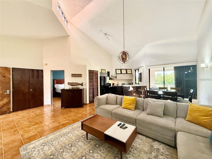 Welcome to this beautifully appointed 2-bedroom, 2-bathroom apartment in Fair Lakes Village, Palmas del Mar. This fully furnished home features high ceilings and an open design that offers exceptional illumination and space. Upon entering, you are greeted by a welcoming foyer that leads to an expansive living area with a stylish sectional sofa and a TV, perfect for relaxation. The dining room seats six comfortably, and the modern kitchen is fully equipped with a refrigerator, stove and oven combo, microwave, and ample storage. The apartment also includes a washer-dryer combo and full AC units in all areas for your convenience. The master bedroom is a serene retreat with an en-suite bathroom featuring a combo shower/tub, double sinks, a bidet, and a toilet. The second bedroom offers a large bunk bed, a sofa, and a TV, making it a versatile space for family or guests. The second bathroom also includes a combo shower/tub, sink, and toilet. Step outside to the ample terrace and enjoy breathtaking views of the golf course and serene ponds. This quiet and breezy space is perfect for outdoor relaxation or entertaining. The apartment is just steps from the community pool, which includes a large pool, lounge chairs, and a kiddie pool. The gated community provides security and peace of mind. As part of Palmas del Mar, residents have access to an array of resort-style amenities. The beach acces is through a path between the condos across the street, with a convenient path across the street. The tennis club, beach club, and over 15 restaurants. The resort also features a school (K-12), an equestrian center, a small supermarket, and 24/7 top-notch security. Enjoy the unparalleled lifestyle of Palmas del Mar in this move-in-ready apartment. Contact us today to schedule a viewing!