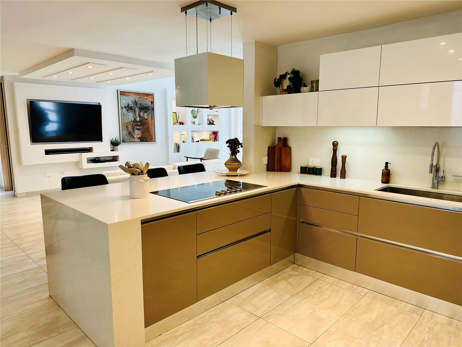 Experience upscale beach living in Sabanera de Dorado. Sabanera de Dorado is a neighborhood located in Dorado, Puerto Rico. It is considered to be one of the premier neighborhoods on the island, with a range of amenities and facilities that make it the epitome of luxury living. This listing is a one-of-a-kind 3,900 square foot estate home located on an oversized lot of 1,046 square meters, providing privacy and easy access to the community through its privileged location. The open-concept interior features 14 ft cathedral ceilings, walls of windows and doors, and an abundance of natural light, offering lush landscape views from the living and dining rooms. The functional kitchen includes ample storage, a large pantry, and top-of-the-line appliances. Each of the four bedrooms has a private en-suite bathroom with upscale tile, quartz vanities, and chrome fixtures. A home office that can easily be converted into a fifth bedroom, and the primary suite features 14 ft ceilings, a walk-in closet, double vanity en-suite bath, and built-in dresser.
