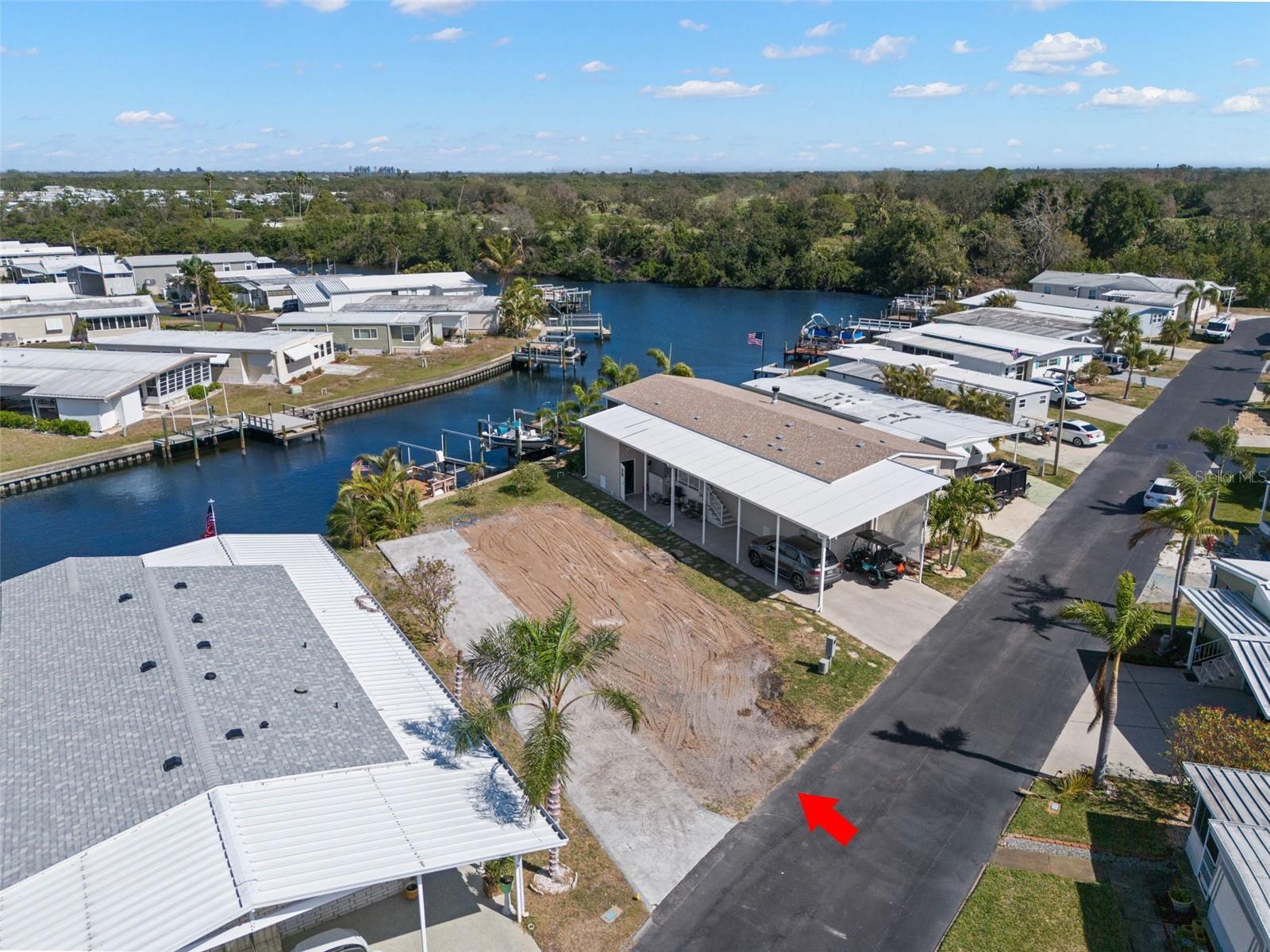 SELLER SAYS SELL!!! PRIME WATERFRONT VACANT LOT WITH DOCK AND LIFT - DIRECT ACCESS TO TAMPA BAY!!
Build your waterfront dream home! Seize this rare opportunity to own a prime waterfront home nestled on a quiet canal. Design your new home on this beautiful lot with dock and lift! The possibilities are endless!! This lot would accommodate a 1300 sq ft modular home with parking and garage underneath. Watch the dolphins and manatees from your new home or dock, go fishing in Tampa Bay, or take a dinner cruise on your boat. Tampa Bay is a 20 min boat ride with no bridges. Price includes share for the lot and ownership in the community. Located in a great neighborhood, close to the boat launch and extra parking. Low monthly HOA of $380 includes water, sewer, trash, lawn maintenance, 24 hr manned gate, pool, clubhouse, newly updated fitness center, shuffleboard, bocce court, and many clubs and activities. Build and design your forever waterfront home in Americana Cove, a 55+ community located 10 min from downtown St Pete, 15 minutes to airports, or 20 minutes from the beaches. 675 or higher credit score required by management.