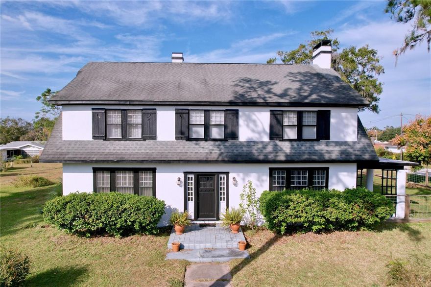 PRICED TO SELL!!  Discover the charm of this historic 1920 Dutch Colonial home in the heart of Dade City! Sitting on a spacious corner HALF-ACRE lot, this beautifully maintained 4-bedroom, 2-bath home is full of character—from original hardwood floors and 11" baseboards to an expansive full attic.  The FRESHLY PAINTED EXTERIOR sets the stage, while large windows fill the interior with natural light for a warm, welcoming feel. Step into the generous 11x17 foyer, where a stunning wood staircase, 10' ceilings, and views of the formal dining room greet you. The sprawling 18x31 living room, complete with a WOOD-BURNING fireplace, is perfect for gatherings, entertaining, or cozy game nights. Just beyond, double French doors open to a relaxing pavered covered porch ideal for enjoying the outdoors.  The formal dining room features a classic swinging door that leads to the eat-in kitchen—an excellent space for cooking and hosting, with ample cabinets, counter space, an island, a huge pantry, and stainless steel appliances. Down the hall, you’ll find a 10x13 mud/laundry room and a full guest bath.  Upstairs are four generously sized bedrooms, all with wood floors. The full bath on this level includes a timeless pedestal sink and a reglazed shower. A second staircase leads to the impressive 22x43 ATTIC, offering incredible storage or the potential for future expansion.  Outside, the oversized fenced yard provides plenty of room for parking and still offers space to add a garage. Additional features include updated plumbing and electrical systems, plus an 11x15 STORAGE SHED.  This one-of-a-kind property blends historic character with thoughtful modern updates and for peace of mind seller is offering a one year HOME WARRANTY.  Schedule your private showing today and experience the charm of this exceptional Congress Park home—just minutes from local shops, restaurants, and schools!  This home should be eligible for USDA financing.