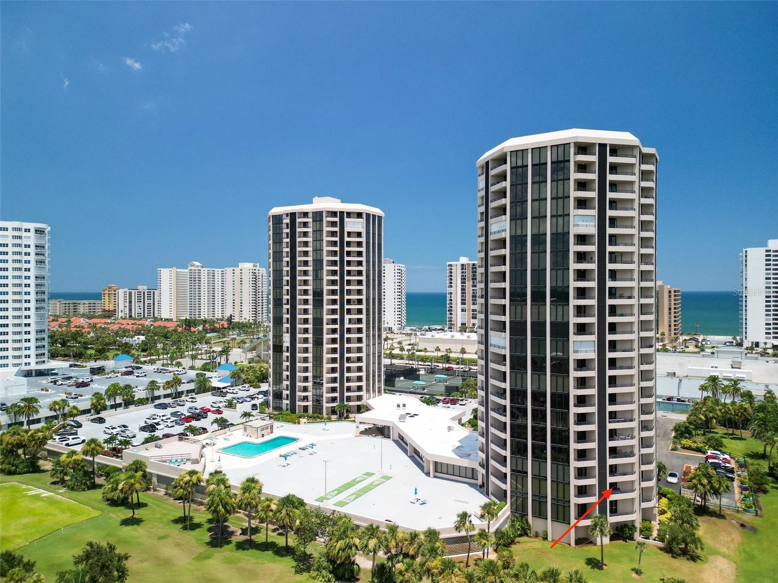 Dreaming of living a beachy but sophisticated lifestyle in Florida? Look no further! Located between the Atlantic Ocean and the Halifax River in the famous Daytona Beach Shores, is Oceans West Condominiums. Here, you will find two beautiful bedrooms and two full bathrooms, all within a gorgeous condominium just waiting for you to make it your perfect home or getaway. This unit is the quintessential blend of luxury and practicality, and it is being sold partially furnished. From the moment you enter this special condo, you are swept away with the view via the floor-to-ceiling hurricane impact windows. With off-white leather furniture to greet you in the beautiful living area, you can't help but notice that this space is special and has everything and more that you need to make living by the beachside extraordinary. The well-appointed modern kitchen features gorgeous counters, stainless-steel appliances, and white modern cabinetry. Architectural and ceramic tiles are throughout the unit. There's even a door to the dining area that offers easy access to one of the two balconies. The master bedroom suite is generously sized, and its bathroom features ample storage, including a walk-in closet. It too has its own balcony. Separated from the guestroom suite, located on the opposite side of the unit, you will find additional storage and a quiet space that family and friends will love for its privacy (and so will you). It features a very private balcony that doubles as a dining space, perfect for enjoying a whole al fresco dining experience while being blessed to live in paradise. The unobstructed view from the two self-contained balconies overlooks an expansive lawn that leads to the only 15-hole, par-3 golf course in the area. If golfing isn't in your interest, then the pristine outside pool and deck may better suit you, or the pickleball and tennis courts just down the block. Open your sliding doors at night and listen to the waves lap the shore, since you are only a few minutes from the beach. Shopping, excellent restaurants, and numerous outdoor sports activities, including fishing, surfing, and NASCAR, are just minutes away. As a resident of Oceans West, your amenities include a library, billiards, sauna, gym, heated pool, community room, and much more. So why wait to make your Florida dream come true? This fantastic condo is the one you have been waiting for and is priced to sell quickly. Schedule your showing today and be ready to enjoy the holidays this year, living in your very own subtropical oasis where the sunsets are expansive and life is grand.
As a side note, One Ocean's West is a two-tower condominium located between the Halifax River and the beach. It is one of the most popular places for condo living in the Daytona Area. The two 22-story elliptical towers contain a total of 247 units. Each tower has six units per floor. The laundry is located on each floor. The complex features an on-site manager, a storage area, and the towers are part of the golf community, which includes a 15-hole, 3-par course that overlooks this unit. Lastly, the towers are tied to the emergency grid, ensuring that this complex will be the last to lose power during a hurricane. All in all, this is a fabulous condo and priced to sell quickly.