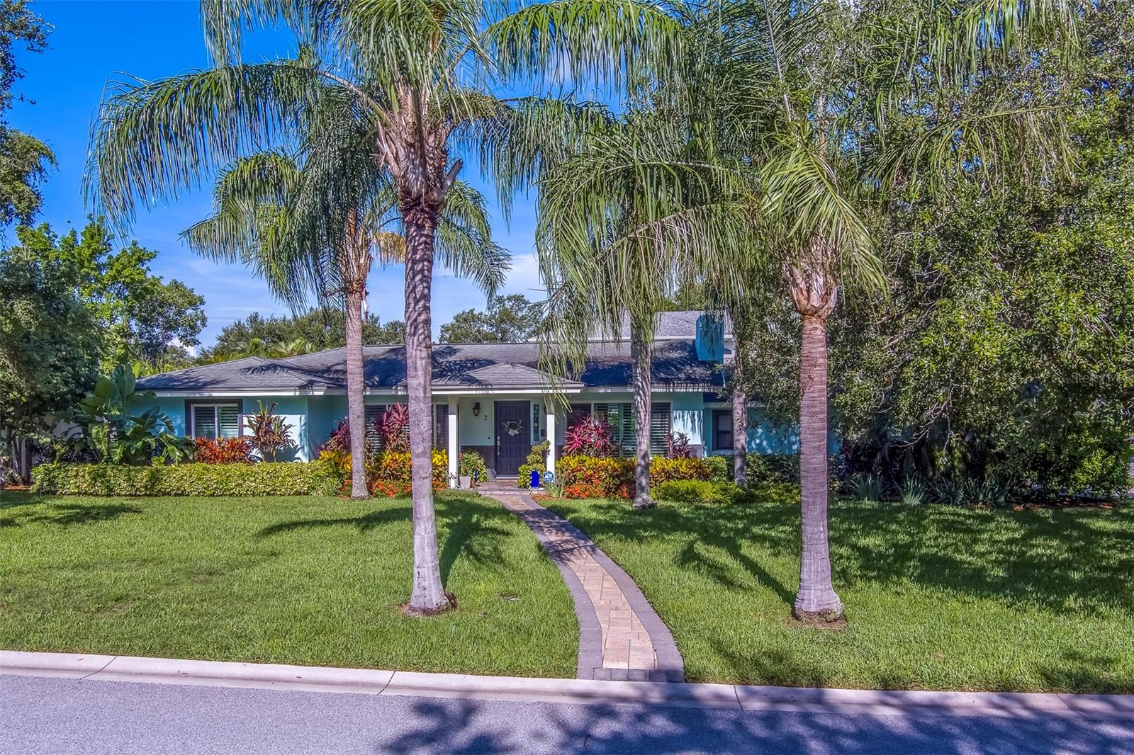 Welcome to a true gem located in the heart of Belleair. Only steps from Pelican Golf Club, Belleair Country Club, dining, and the world class beaches of Pinellas County. Take a step into this beautifully renovated residence at 2 Evonaire Cir. This home offers a unique blend of modern luxury and classic charm. This 3 bedroom home boasts 1,520 sqft of living space, from an elegant layout to top-of-the-line security and safety features assured to withstand Florida tropical weather, including all-block construction, hurricane windows throughout (2022), impact rated garage doors and a Generac generator to power the entire house. This home even comes complete with a pavered side-drive, 2 car garage and a sparkling pool. As if there wasn't more to brag about, the private backyard is a tranquil oasis and where this home really shines; boasting lush landscaping a huge corner lot with maximum privacy, a screened-in porch allowing you to take full advantage of your outdoor space. Whether you're hosting gatherings or enjoying quiet evenings at home, this property has it all. With its upgrades and prime location, 2 Evonaire Cir is more than just a house; it's a place you'll be delighted to call home. Features: Completely renovated and upgraded bathrooms, beautifully updated kitchen with stainless steel appliances, HVAC (2021), water softener, luxury vinyl plank flooring throughout, gas fireplace, tankless hot water heater and so much more. Don't miss the opportunity to own this exceptional home. Schedule your private tour today and experience the beauty of 2 Evonaire Cir for yourself!