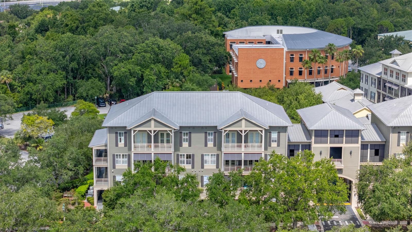 This exceptional penthouse offers a unique blend of luxury and comfort, perfect for those seeking an upscale lifestyle in Celebration. Enjoy panoramic views from two covered balconies, ideal for watching town activities and fireworks. The home is adorned with premium finishes, including Brazilian Cherry random width floors, crown molding, wainscoting, and plantation shutters, creating an elegant and cohesive aesthetic. The gourmet kitchen is a chef's dream, featuring stunning cherry cabinetry, granite countertops, stainless steel appliances, a full tumbled backsplash, under-counter accent lighting, and a spacious eat-in breakfast area flooded with natural light. The luxurious master suite includes an expansive walk-in closet and a master bath with a raised double vanity, oversized garden tub, and separate shower for added convenience. Additional amenities include conveniently located laundry facilities on the same floor as Primary suit and 2 bedrooms offers flexibility for guests or additional living space. The well-appointed living room complements the overall design of the home, providing a perfect space for relaxation and entertaining. With its exceptional views and high-end finishes, this penthouse is a rare opportunity to experience the best of Celebration living. AC and hot water heater replaced. Don’t miss your chance to make this exquisite home yours!