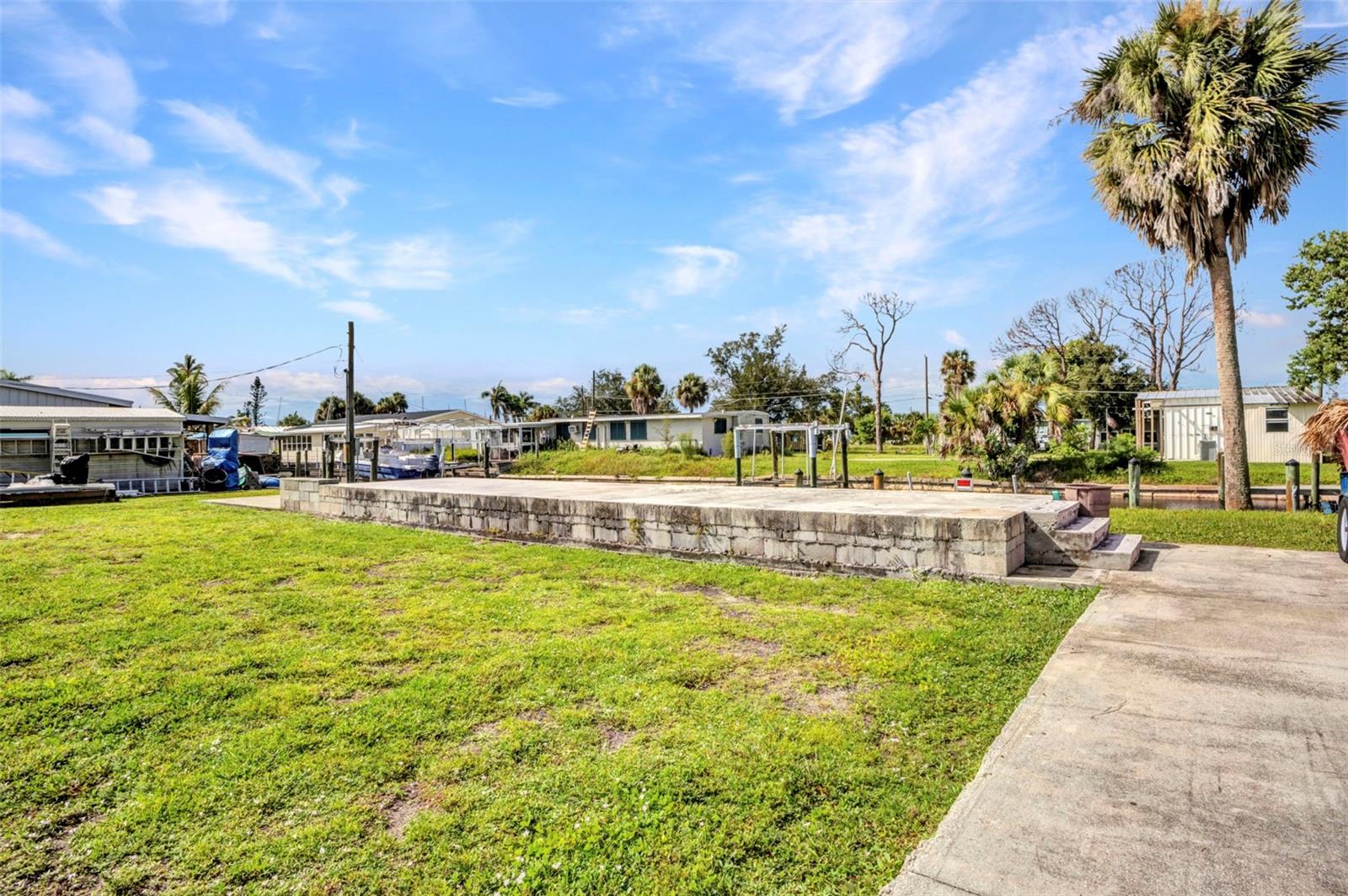 Ready to build your Florida dream home? This 80x100 waterfront lot in historic El Jobean offers the perfect canvas. Known as one of the Gulf Coast’s best-kept secrets, El Jobean was once a lively fishing village and still carries its laid-back charm with live music, local parks, and a welcoming small-town feel.
The property features a solid cement seawall and direct access to deep-water canals — ideal for sailboats and serious anglers alike. With Charlotte Harbor and the Gulf of Mexico just minutes away, you’ll enjoy some of the best fishing waters in the country. Shopping, dining, and recreation are close by, yet the setting retains the relaxed, old Florida atmosphere that makes El Jobean so special.
Build here, and let the magic of coastal living begin.