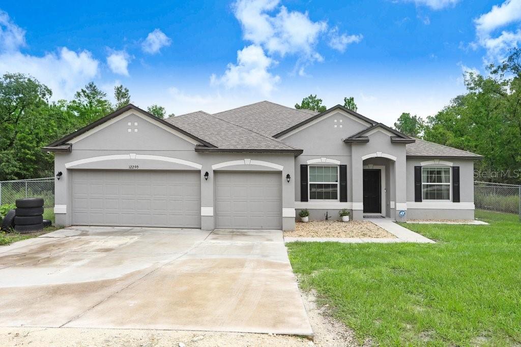 Tucked at the end of a quiet, tree-lined street, this move-in-ready 4BR/3BA, 2,400+ SF home pairs everyday comfort with flexible living. A welcoming foyer opens to a bright, open concept anchored by a large family room and a granite-topped island kitchen with stainless appliances, walk-in pantry, and breakfast bar seating. Formal dining sits up front, while an adjacent flex room works perfectly as a living room, playroom, or home office. The private primary wing is a true retreat—spacious enough for a sitting/desk area—with tray ceiling, walk-in closet, and ensuite bath. Three secondary bedrooms and two additional full baths provide excellent separation for guests or multigenerational living. Indoor laundry, abundant storage, crown accents, and easy-care tile in high-traffic areas add convenience. Outside, a screened lanai overlooks an oversized backyard with no rear neighbors—plenty of space to garden, play, or plan a future pool. A 3-car garage offers room for vehicles and gear. Enjoy the privacy of a deep lot and the versatility of a smart split-bedroom layout—all in a contemporary single-story design ready for its next chapter.