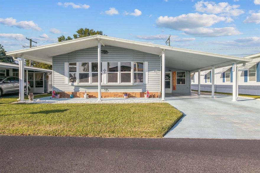 Welcome to Oakwood Estates, one of Winter Haven’s most sought-after 55+ co-op communities! This well-maintained home offers an inviting open floor plan with cathedral ceilings that make the living area feel bright, airy, and spacious. You’ll love the luxury vinyl plank flooring throughout the living area, hallway, and primary bedroom, easy to maintain and beautifully updated.The primary bedroom is oversized and features a fantastic walk-in closet with room for everything. Both the kitchen and primary bath have updated countertops, and the hall bath has a newer vanity for a fresh look. Off to the side, you’ll find an enclosed porch that adds great extra living space, complete with a separate workshop at the back, perfect for projects or storage, and neatly tucked away behind a closed door when guests stop by.Step out back and you’ll discover one of this home’s best features, a large deck overlooking open greenspace owned by the county, meaning you’ll have no rear neighbors building behind you. The roof-over adds extra insulation and the AC was replaced in 2019 for peace of mind. Some of the other updates include windows, skirting, siding and kitchen cabinets. This home will be sold mostly unfurnished, but the beds, living room TV stand, and generator will stay. Oakwood Estates is an active 55+ co-op community offering a long list of amenities including swimming, shuffleboard, tennis, horseshoes, and plenty of daily activities to enjoy. Don’t wait, call today for your private showing of this wonderful home and start enjoying the Florida lifestyle you’ve been waiting for!