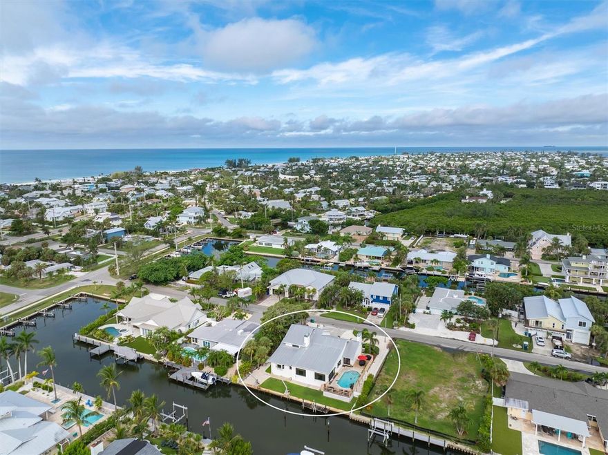 Discover paradise at this stunning canal front retreat that includes 5 bedrooms and 3.5-bathrooms.  Located in the heart of Holmes Beach just a short stroll to the Gulf Beaches, restaurants, shops and more!  This renovated gem offers modern elegance situated on a serene canal with direct access to Tampa Bay, ideal for boat lovers!  Step inside to an open-concept living space, featuring Brazilian walnut floors, fireplace and natural light that shines through the impact hurricane windows and doors.  Enjoy the gourmet kitchen, complete with custom cabinetry, sleek stainless steel appliances, marble countertops and more!  The master suite is conveniently located on the main level with a walk in closet and a fireplace. It is a private oasis, boasting a spa-inspired ensuite with dual vanities and a walk-in shower. Four additional bedrooms provide ample space for family, guests, or a home office/gym.   Outside, your tropical haven awaits. Dive into the sparkling pool, relax on the expansive deck, or take your boat straight from your private dock to explore the open waters. With lush landscaping and breathtaking canal views, this backyard is perfect for sunset gatherings or quiet mornings with coffee in hand.  Located just steps from the pristine beaches of Anna Maria Island, this home offers the ultimate Florida lifestyle.  This home has been lovingly  enjoyed and very well taken care of by the full time owners.  Schedule your private tour today!