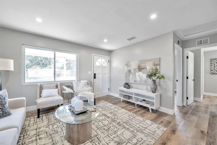 Wow! This beautifully renovated home can be yours! You'll love the updated kitchen with brand new cabinets, new countertops, and new stainless steel appliances.  The updated bathroom includes a tub/shower combination. There is brand new wood-look vinyl flooring throughout the home.  The house was freshly painted inside and out.  New roof in 2023.  Brand new air conditioning system. Most of the windows have been updated. Brand new water heater. Spacious laundry room at the back of the garage. Covered lanai allows you to relax outdoors and also adds extra space for entertaining family and friends. With the corner lot and alley access you could park your boat or RV in the backyard. Ideal location near downtown St Pete with so much to do including hanging out at The Pier, restaurants, shopping, museums, etc.  About 15 minutes from beaches. So close to parks with pickle ball and tennis courts, pools, dog parks, and so much more. Welcome HOME!