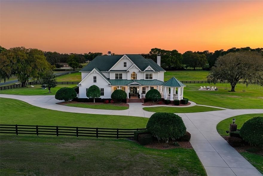 Exquisitely renovated and set on nearly 14 acres on 2 contiguous parcels in the highly desirable Greenway Crossing community, this exceptional estate delivers the rare combination of timeless Southern architecture, modern luxury finishes, and true estate-scale living—just minutes from the Santos Trail system and the heart of Ocala’s premier horse country.

Greeted by custom iron Milano doors on the southern charm front porch, the home has been completely reimagined with a designer’s eye with flooring throughout showcases a curated blend of Thassos & Nero Marquina marble, French limestone, and stunning Herringbone White Oak, creating a layered, high-end aesthetic that is both bold and timeless. The layout of the home surrounded in wrap around porches is perfect for families and entertaining with multiple spaces to enjoy watching movies, eating and or lounging. 

The kitchen is a true showpiece—designed for both entertaining and everyday luxury—featuring all brand new gunmetal DACOR appliances including a double sub fridge, two ovens, 4 burner gas cooktop with griddle, an ultra lux wine dispenser, elite cabinetry, quartz countertops, gold fixtures / lighting and a custom butcher block island that anchors the space with warmth and functionality overlooking the sparkling pool.

Additional upgrades include Lutron smart lighting controls, integrated LED lighting, HEOS whole-home audio system, custom Milano iron doors, Buster & Punch hardware, and designer Graham & Brown wallpaper accents. 

Outdoor living is equally impressive, with a screened pool and spa equipped with Pentair ScreenLogic controls, expansive brick paver entertaining areas, and covered spaces designed to capture the peaceful views of the surrounding acreage.

The property is fully fenced with classic black board fencing and adorned with mature oak trees, offering open pasture and a detached oversized Kentucky style barn currently set up as a gym with full Bath and 1500 Sq. ft. second story that could be finished with versatile use including a very simple transition to a European 6 stall Stables or recreational use.

Whether you're hosting under the oaks, enjoying quiet mornings on the wraparound porch, or entertaining poolside as the sun sets over the pasture—this property doesn’t just check boxes… it creates moments and a lifestyle that’s getting harder to find and impossible to recreate at this level. The sunsets are INCREDIBLE!