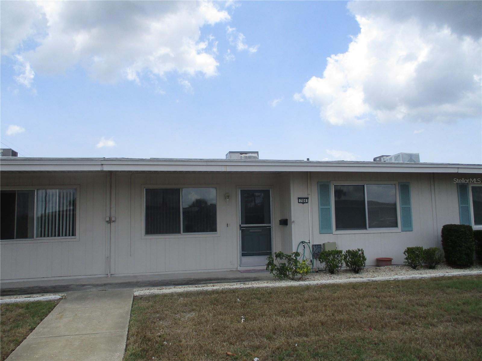 ANNUAL LEASE ONLY. AVAILABLE JUNE 1, 2025. Welcome home to this unfurnished, remodeled 1 bedroom, 1 bath villa with an attached carport. There is easy care laminate flooring throughout. The kitchen is equipped with a built in microwave, side by side refrigerator with ice and water in the door, ceramic top stove and disposal. A washer and dryer are conveniently located in a room off the kitchen. The bedroom is large enough for a king size bed and has a wall closet. The bathroom has a step in shower with a grab bar, comfort commode and raised vanity. Central heat and air as well as ceiling fans in the living room, bedroom, lanai and 2 in the kitchen will keep you comfortable all year round. Enjoy an early morning cup of coffee in the private courtyard/lanai. Water, lawn care and 2 Community Association memberships are included in the rent. Cats or small dogs welcome. No smoking.