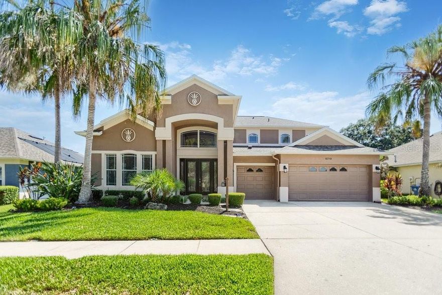 Wake up each morning to peaceful lake views and the beauty of nature surrounding you in this stunning FULLY UPDATED waterfront home located on a premium homesite in the guard-gated community of Lakeshore Ranch in Land O' Lakes. Offering over 3,000 square feet of thoughtfully designed living space, this spacious 4-bedroom, 3-bath, 3-car garage home blends luxury, comfort, and the ultimate Florida outdoor lifestyle.One of the most unique features of this property is the ability to enjoy kayaking, fishing, and exploring the spring-fed lake right from your own backyard. Whether you're casting a line at sunrise, paddling across the water in the evening, or simply relaxing poolside while taking in the tranquil views, this home offers a true waterfront retreat with no rear neighbors and nature as your backdrop.A grand double-door entry welcomes you into the soaring two-story foyer with an open rail staircase and beautiful new flooring throughout. The flexible floor plan offers multiple living and entertaining spaces, including a formal dining room, spacious family room, and versatile flex space perfect for a home office, fitness room, or additional storage. The rare multi-generational layout includes two primary suites, one downstairs and one upstairs, providing flexibility for guests or extended family living.
The beautifully redesigned kitchen serves as the heart of the home, featuring white quartz countertops with soft gray veining, white cabinetry accented with gold hardware, a contrasting navy blue island, high-end stainless steel appliances, a walk-in pantry, and a dedicated coffee bar with built-in wine refrigerator. The sunny breakfast nook overlooks the pool and sparkling lake beyond, creating the perfect setting to start your day.Step outside to your private backyard paradise designed for entertaining. The newly resurfaced epoxy pool and spa invite year-round enjoyment, while the outdoor dry bar with granite countertop makes hosting effortless. Whether you're gathering with friends, enjoying sunset cocktails, or watching wildlife along the shoreline, this outdoor space is truly exceptional.The first-floor owner's suite offers a peaceful retreat with private lanai access, a spacious walk-in closet, and a luxurious ensuite bath with dual vanities, soaking tub, and separate shower. Upstairs, the oversized loft provides endless possibilities as a game room, media room, fitness area, or additional lounge space. Generously sized secondary bedrooms offer comfort and privacy, many with beautiful water views.
Enjoy peace of mind with major recent updates, including a 1-year-old roof with transferable warranty, a one-year home warranty, all new flooring, and fresh interior paint throughout. This move-in ready home eliminates many of the big-ticket maintenance concerns for the next owner. Residents of Lakeshore Ranch enjoy resort-style amenities including a guarded gate, clubhouse, fitness center, lap pool, adult pool, children's pool, tennis courts, basketball courts, dog park, playgrounds, and scenic walking trails. Conveniently located near I-75, Tampa Premium Outlets, shopping, dining, golf, schools, and everyday conveniences, this exceptional waterfront home offers the perfect combination of luxury, recreation, and relaxation.If you've been dreaming of a home where you can entertain in style, launch a kayak from your backyard, spend weekends fishing on a spring-fed lake, and enjoy breathtaking water views every day, this is the one.