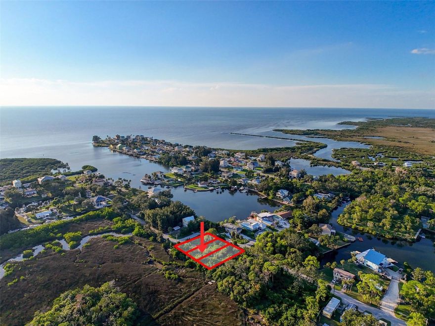 Bring your vision to life on this undeveloped lot in the Driftwood Isles Waterfront Community, part of Florida’s Sports Coast! Lot 11 on Nowiki Avenue, positioned just a touch closer to the Gulf than neighboring Lot 10 W7879563, is available individually or as part of a package with Lot 10 W7879563 and corner Lot 12 W7879570, which features a partial water view. This is an excellent opportunity for builders, investors, or anyone seeking a build-to-suit retreat in a coastal setting. The rear of the property borders peaceful marshland with natural creeks and no rear neighbors, providing privacy and a serene Old Florida backdrop. While not directly waterfront, the area is surrounded by boating and fishing opportunities with Hudson Beach’s public boat ramp, nearby marinas, and fishing docks all just minutes away. Local favorites such as Sam’s Beach Bar, Inn on the Gulf, Ollie’s on the Beach, and Get Hooked Grill are close by, along with everyday shopping, medical centers, and conveniences. In about an hour, you can explore Tampa Bay, Clearwater Beach, Tarpon Springs, Honeymoon Island, Pine Island, and Weeki Wachee Springs. Build your own slice of the Gulf Coast lifestyle — or maximize potential with the multiple-lot package. Call Today! Some marketing images include AI-generated visual effects to help illustrate potential home placement and lot perspective. These are conceptual only. No homes currently exist on the property; the land is undeveloped.