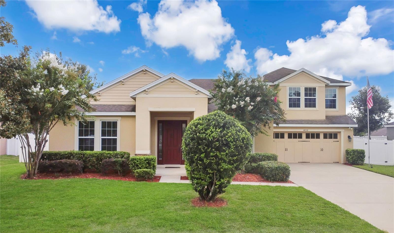 With its blooming crepe myrtles, sculpted hedges, longer driveway, and carriage-style garage door, this home presents a welcoming look that instantly feels like home. The covered entry frames a warm front door, setting the tone for a place that looks and feels like home. Inside, high ceilings and natural light stretch across a layout that’s both spacious and practical. Up front, the living room and dining room give you oversized spaces to gather, while the split floor plan offers privacy in every direction. Three bedrooms sit toward the front of the home, with two sharing a hall bath and the other enjoying a private ensuite with direct access to the lanai and pool. At the center, the kitchen is built for connection — a large island with breakfast bar, stainless steel appliances, a walk-in pantry, and a cozy breakfast nook, all overlooking the expansive family room and screened pool beyond. The primary suite sits in its own wing, complete with lanai access, a walk-in closet with custom built-ins, and a huge ensuite with dual vanities, soaking tub, and walk-in shower. Upstairs, the oversized second-level flex room is more than just extra space. With its size, dual closets, and private full bath, it easily functions as a fifth bedroom, media room, or guest retreat. Out back, the lifestyle shines. A wide covered lanai stretches to a screened pool and spa, framed by a large fenced yard with room to play, garden, or just breathe. It’s the kind of space that’s easy to imagine living in — sunny, private, and ready for whatever comes next. Set in Chandler Estates, this home keeps you close to everything that makes Apopka such a draw. Outdoor escapes like Kelly Park and Wekiwa Springs are minutes away, offering trails, springs, and weekend adventures. Everyday convenience is easy too, with nearby shopping, dining, and quick access to the 429 for smooth commutes across Central Florida. In a neighborhood that feels tucked away yet connected, this home delivers the space, the setting, and the lifestyle you’ve been looking for.