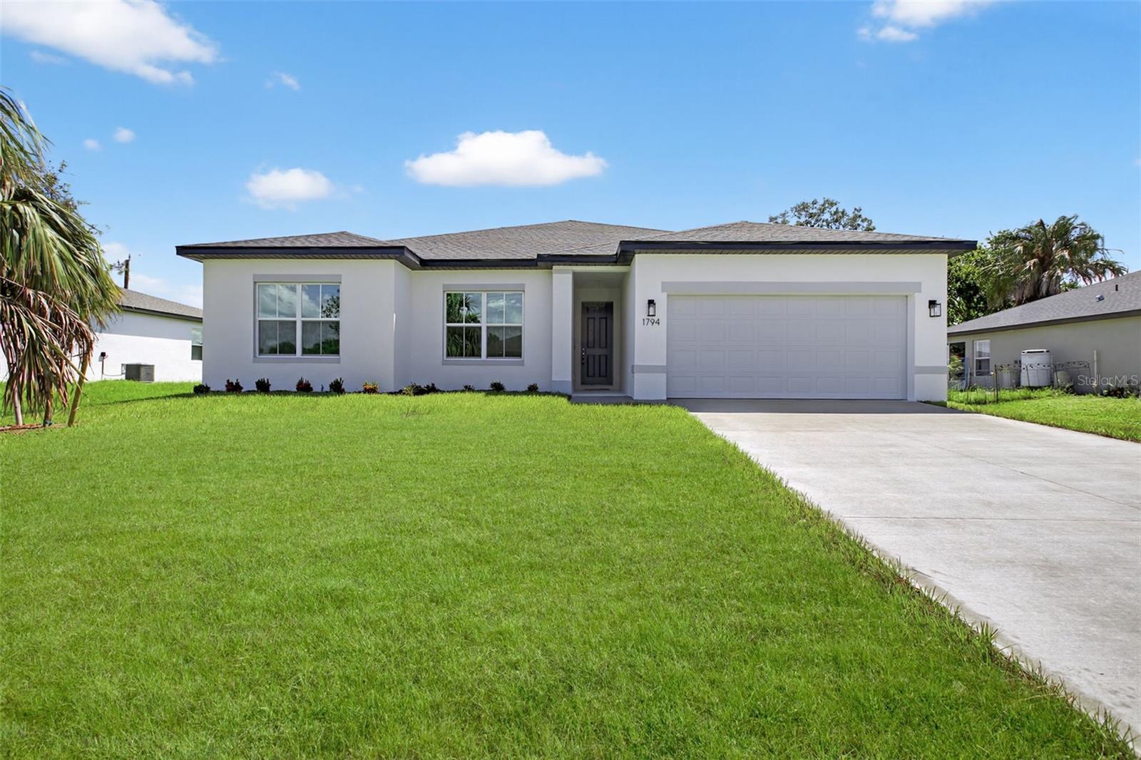 One or more photo(s) has been virtually staged. Under Construction. **THIS PROPERTY QUALIFIES FOR A 1% LENDER INCENTIVE IF USING PREFERRED LENDER. INQUIRE FOR MORE DETAILS.** Ask about Builder Incentives! Discover the perfect blend of modern design and thoughtful craftsmanship in this stunning new construction 4-bedroom, 3-bathroom home, ideally located in the heart of North Port. From the moment you step inside, you’ll be captivated by the soaring 9’4” ceilings that create a bright and airy ambiance throughout. The open-concept living area is designed for effortless entertaining, anchored by an impressive 8’ triple-panel sliding glass door that invites natural light and seamlessly connects to the covered lanai—ideal for enjoying Florida’s indoor-outdoor lifestyle. The chef’s kitchen is a showstopper, complete with gleaming Quartz countertops, Samsung stainless steel appliances, elegant 42” upper cabinets, and an oversized island that serves as the heart of the home—perfect for prepping, dining, or gathering with loved ones. The Owner’s Suite is a true retreat, featuring a sophisticated tray ceiling and a spa-like ensuite. Enjoy a dual-sink vanity, a sleek glass-enclosed shower, and his-and-hers walk-in closets that offer abundant storage. The additional bedrooms are generously sized, with ample closet space, while the guest bathrooms elevate the home’s appeal with floor-to-ceiling tiled tub/shower combos for a modern touch. Functionality meets style in the thoughtfully designed laundry room, complete with extra linen storage and a washer and dryer included—ready to simplify your daily routine. Please note: Photos are of a model home at a different location. Finishes and colors may vary.