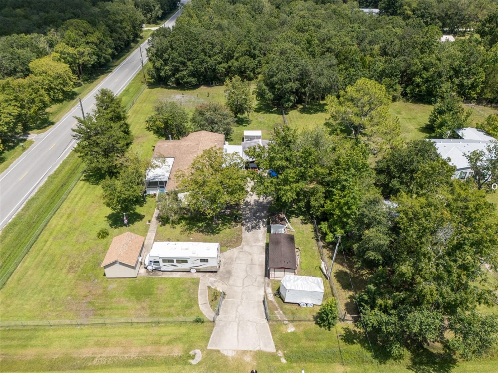 Welcome to this stunning 3-bedroom, 3-bathroom Triple Wide Manufactured Home offering a generous 2104 sq ft of living space. Perfectly designed for comfortable living, this home boasts a family room with a cozy fireplace and a beautifully updated kitchen with modern appliances. Freshly painted interiors and water-resistant flooring throughout provide a stylish, durable living environment.
Enjoy two screened-in porches, ideal for relaxing while enjoying the fresh air. The updated plumbing and bathrooms feature contemporary fixtures, and the property includes a water system for added convenience. The home sits on a fenced 135x300' lot, providing privacy and space for outdoor activities. A carport and concrete driveway has ample parking, while a concrete slab under the home ensures stability.
Additional features include sheds for extra storage, Electric hookup for RV and Plenty of space to park work trucks, trailers, boats,
and all your toys.
2016 roof, and a 2023 A/C and hot water heater, giving you peace of mind with recent upgrades. Located in a peaceful rural setting, this home is the perfect blend of modern convenience and serene country living.