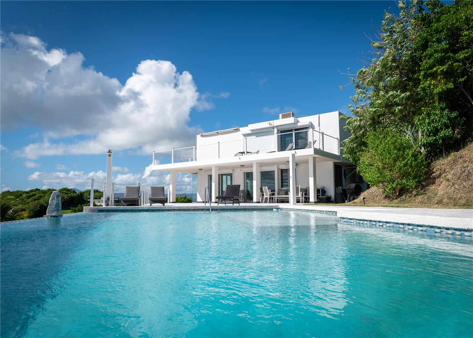 Enchanting Mediterranean-Style Villa with Panoramic Ocean Views. Experience the ultimate in Caribbean coastal living with this captivating Mediterranean-style villa, idyllically situated between the breathtaking shores of the Caribbean Sea and the Atlantic Ocean. Boasting panoramic ocean views and a resort-style infinity pool, this exquisite property invites you to indulge in elegance, comfort, and serenity.
Set on a generous 5,271.75 square meter lot, the villa features a thoughtfully designed layout that offers both privacy and open-concept living. On the second level, you'll find a luxurious master suite with a private balcony overlooking the ocean and a spa-inspired master bathroom. Three additional bedrooms, another full bathroom, and an additional balcony complete the upper floor — perfect for hosting guests or accommodating family. The first floor showcases a spacious open-concept kitchen and living area with breathtaking ocean and pool views, a formal dining room, and a cozy family room ideal for creating lasting memories. Step outside and discover a beautifully designed porch, perfect for relaxing or entertaining while enjoying the stunning seascape. The custom-built outdoor grill and BBQ area set the stage for unforgettable gatherings by the pool.
Every detail of this villa reflects a commitment to luxurious Caribbean-style living, making it the perfect tropical retreat or investment opportunity.