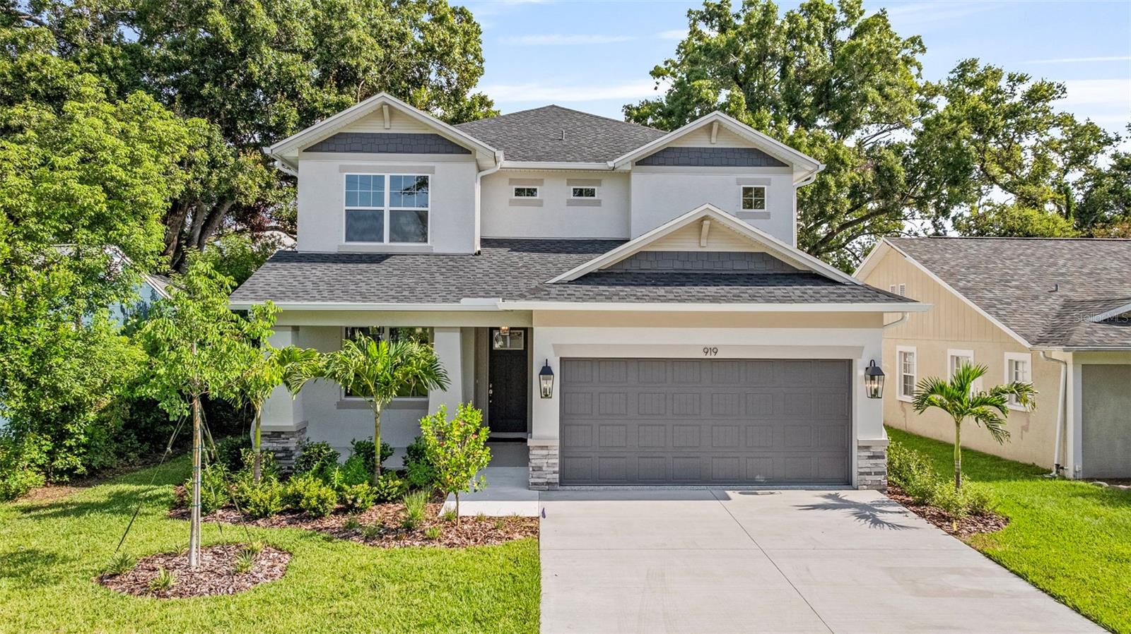 Welcome HOME to a stunning new build located in desirable Riverside Heights. This exquisite home was built with on slab with a stem wall foundation and a durable block and stucco exterior, complete with hurricane shutters for ease of ownership. From the moment you arrive, you’ll fall in love with the curb appeal and the extended porch, perfect for your morning coffee or relaxing evenings. Set on a peaceful, low-traffic street, this home offers a safe and welcoming environment where you can comfortably watch kids play out front, converse with neighbors, or walk your 4 legged friends. Just one house away from the charming Plymouth Park, a well-maintained community space that includes a playground and plenty of green space for outdoor fun. You can even walk to Armature Works and the Riverwalk! Inside, you’ll discover a thoughtfully designed interior filled with timeless finishes and numerous upgrades beyond the standard build, including engineered oak hardwood floors throughout. Step into the oversized dining room and bonus space once you enter the home. The bonus space can be walled off completely to make an at-home office or playroom, and you would still have plenty of space for a dining table for 10. Off to the right is a bedroom and a full bathroom, conveniently located next to the garage (With epoxy floors!) entrance, ideal for guests, in-laws, or an office setup. Moving through the dining area, you’ll find the gourmet kitchen featuring sleek quartz countertops, 42" cabinets, elegant upgraded tile backsplash, Whirlpool appliances, and pantry. There is the perfect nook next to the pantry where a bar cart or coffee corner could go! The kitchen is wide open to the family room, creating a welcoming flow for entertaining, and includes bar seating for casual dining or morning breakfasts. The family room is absolutely massive, with ample natural light and room for a sectional and even the La-Z-Boy chair that your significant other refuses to trash. Through the sliding glass doors, step onto an extended and fully covered lanai that truly sets this backyard apart. With room for outdoor furniture, dining, and lounging, this covered outdoor space is perfect for year-round enjoyment. The spacious backyard is fully enclosed by a new white PVC privacy fence and offers plenty of room to add a pool, garden, or playground, making it a true blank canvas for your outdoor dreams. The cherry on top is the backyard alley access through the gate! Upstairs, a large loft provides endless possibilities for use as a media room, play area, gym, or fifth bedroom conversion. Two additional bedrooms are tucked just off the loft, separated by the full guest bath with a double vanity and shower/tub combo. At the end of the hallway lies the generously sized laundry room featuring a built-in sink, and plenty of storage space. On the other side of the loft there are double doors that open to the luxurious primary suite, complete with tray ceilings and copious amounts of natural light. The en-suite bathroom features a free-standing soaking tub, a walk-in glass shower, and dual vanities, while the oversized walk-in closet offers an impressive amount of space for storage. Additional features include upgraded light fixtures throughout, classic exterior coach lights, dual front porch lights, and ceiling fans added in both the living room and primary suite. This home is the perfect blend of style, function, and location, nestled in one of Tampa’s most desirable neighborhoods.