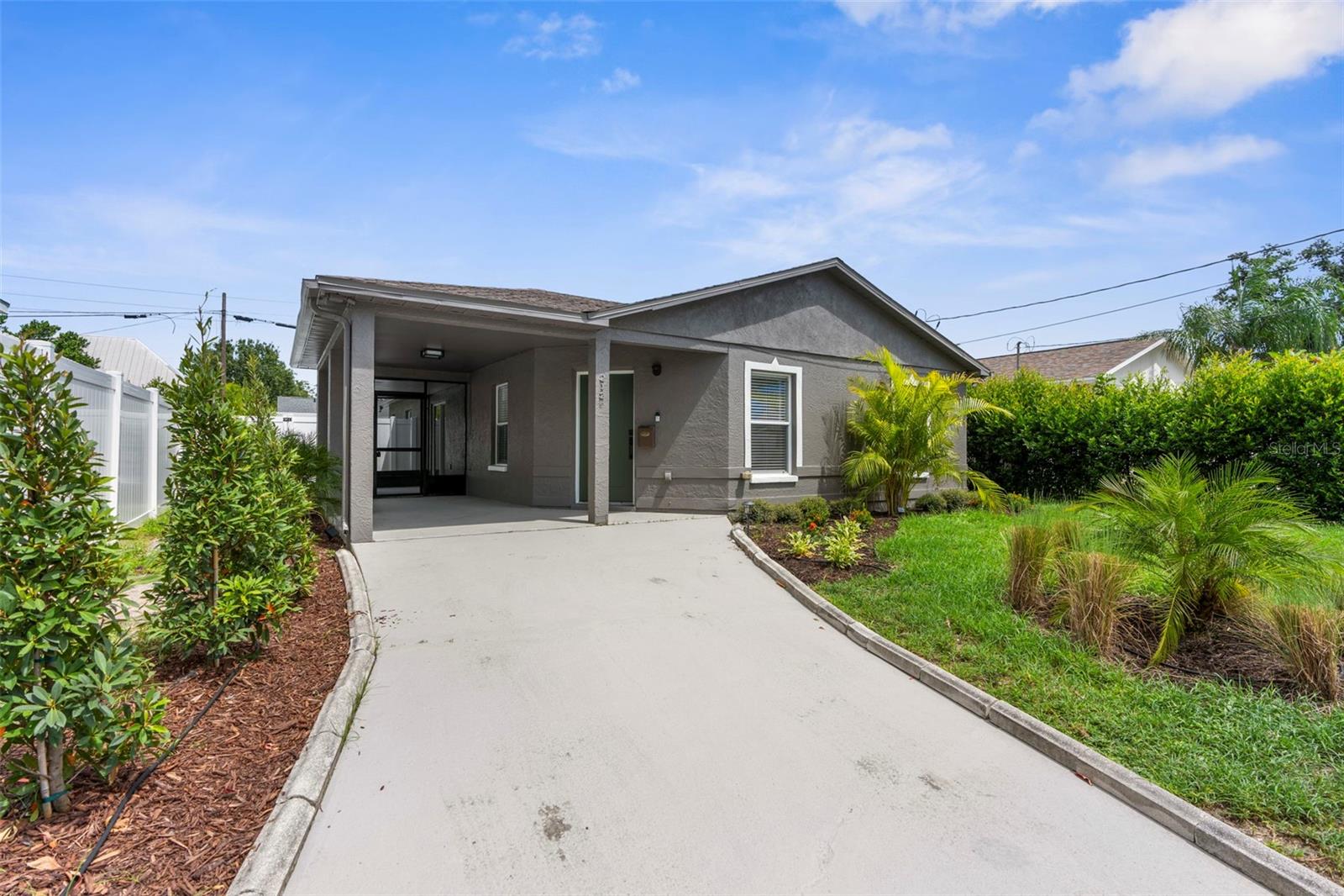 Built to last and reimagined for today’s living, this solid concrete block home (1994) with a 2021 roof has just undergone a complete designer-led remodel in 2025. Every detail has been elevated—this is not a basic flip, but a thoughtfully executed transformation that combines quality construction with a fresh modern aesthetic.
Step inside to light-filled living spaces with wide-plank engineered wood flooring throughout (no carpet), all new recessed lighting, solid-core interior doors, new trim and baseboards, and designer-selected fixtures and fans. The open-concept living room flows seamlessly into the kitchen and screened patio, creating a natural hub for entertaining. The kitchen features quartz countertops, a sleek tile backsplash, modern cabinetry, stainless steel appliances, and island seating for two.
The home offers 3 bedrooms plus a flexible bonus room that can function as an office or dining area, and 2 fully remodeled bathrooms with all new vanities, fixtures, and tile work. The primary suite includes a spacious closet and a beautifully updated bath.
Curb appeal has been redefined with new professional landscaping, landscape lighting, fresh exterior paint, and a covered carport. High ceilings, abundant natural light, and a highly functional layout make the home feel even larger than its footprint.
Situated in North Hyde Park just blocks from the University of Tampa, Downtown, Julian B. Lane Riverfront Park, and the Tampa Riverwalk extension, this location places you near Psomi’s dining and the Bryan Glazer JCC. Surrounded by ongoing growth and development, this home blends timeless structure with a prime investment in Tampa’s future.