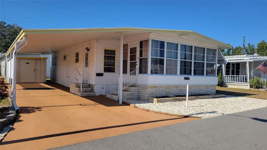 Enjoy living in paradise at Sky Harbor Estates mobile home community, small and friendly park on Old Tampa Bay.  Priced to sell now! This Doublewide mobile home with aluminum roof-over, has an additional 160ft sunny, enclosed Florida room, great for relaxing or party. This 2 bedroom 2 bathroom single story, enjoys one bath with wide counter space and walk in shower and the other bath has a tub shower combo functional as is, or ready for your updates. The large storage shed, is attached to the 2 car, plus covered carport with a newer washer. Dryer hookup available. The well-maintained HVAC system was installed 5 years ago. The furnishings are functional and ready for new owner to move right in. Nice sized 50'x70' lot is deeded and is included in the purchase price. Flooring allowance considered with reasonable offer. This active community with many snowbirds includes a heated/cooled swimming pool, waterfront for fishing, kayaking or canoeing and shuffleboard courts. Imagine sitting on the bench waterfront or in your own golfcart watching the birds and often times dolphin frolic in this peaceful atmosphere. Great convenient location close to buses, airports shops, restaurants and more! HOA approval is required, deed and age restricted community with no renting for the first 3 years of ownership.