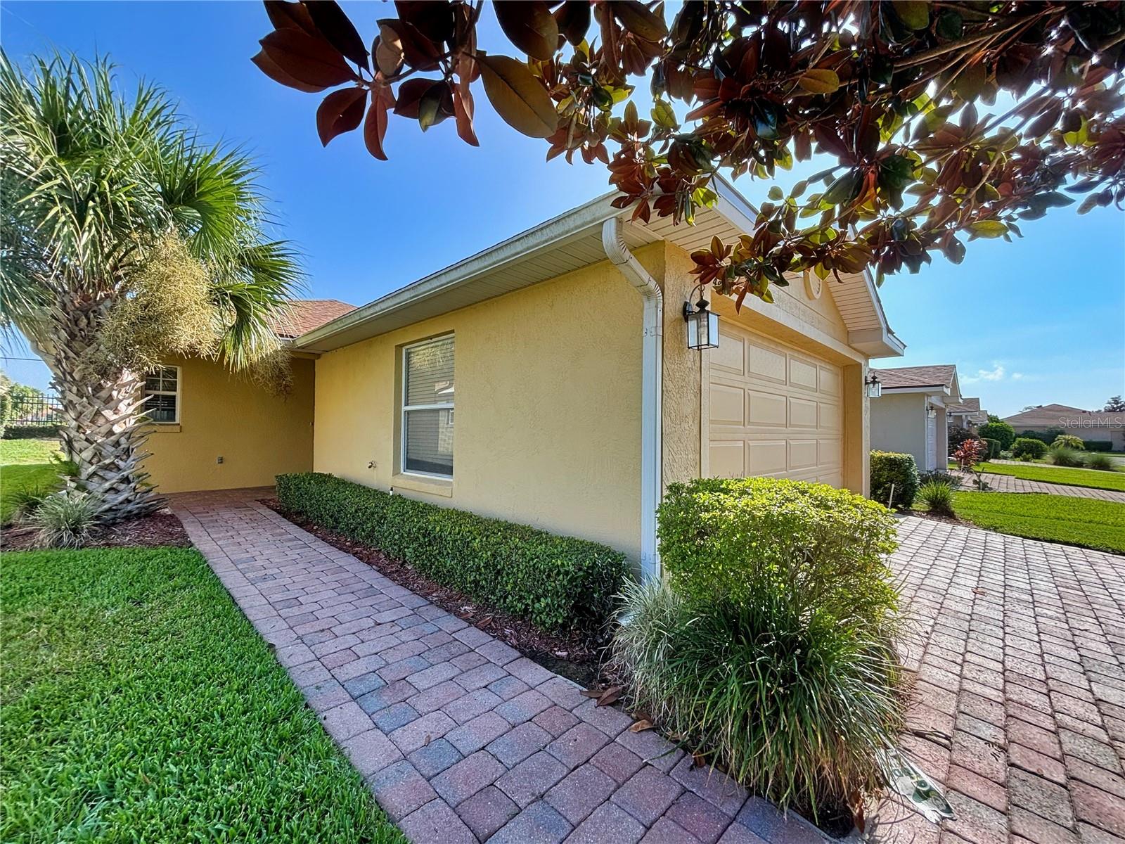 4412 Turnberry Lane Lake Wales, Florida is located behind the gates of Lake Ashton. This 2 bedroom 2 bath home could be the perfect "snowbird" home. With over 1,000 sq. ft. this open floor plan home features a galley kitchen with large breakfast bar that overlooks the spacious living room. Flooring includes carpet in the bedrooms and living area and tile in the wet areas. Enjoy relaxing in your covered and enclosed lanai (Acrylic Windows) with sliders as you take in the serenity of this peaceful, yet active community. The primary bedroom is located on the back of the home with a spacious walk in closet and ensuite with walk in shower. Roof was replaced 2021, Hot Water Heater was replaced July 2025, Side Entry Garage Door Replaced 2025. Washer/Dryer will convey with the sale of this home. The Seller is offering a $2,000 credit to the Buyer to be applied towards closing costs and prepaids at the time of Closing. Lake Ashton community offers two golf courses (golf memberships optional) a bowling alley, movie theater, heated indoor and outdoor pools, tennis courts, bocce, pickle ball, boat access, two clubhouses, health & fitness center, full service restaurant, grand ball room, 1/2 court basketball, full court racquetball, and 24 hour guard gated security. Minutes from Eagle Ridge Mall, Legoland, Hwy 27, Cypress Gardens Blvd for restaurants, retail, and entertainment. This is a must see!