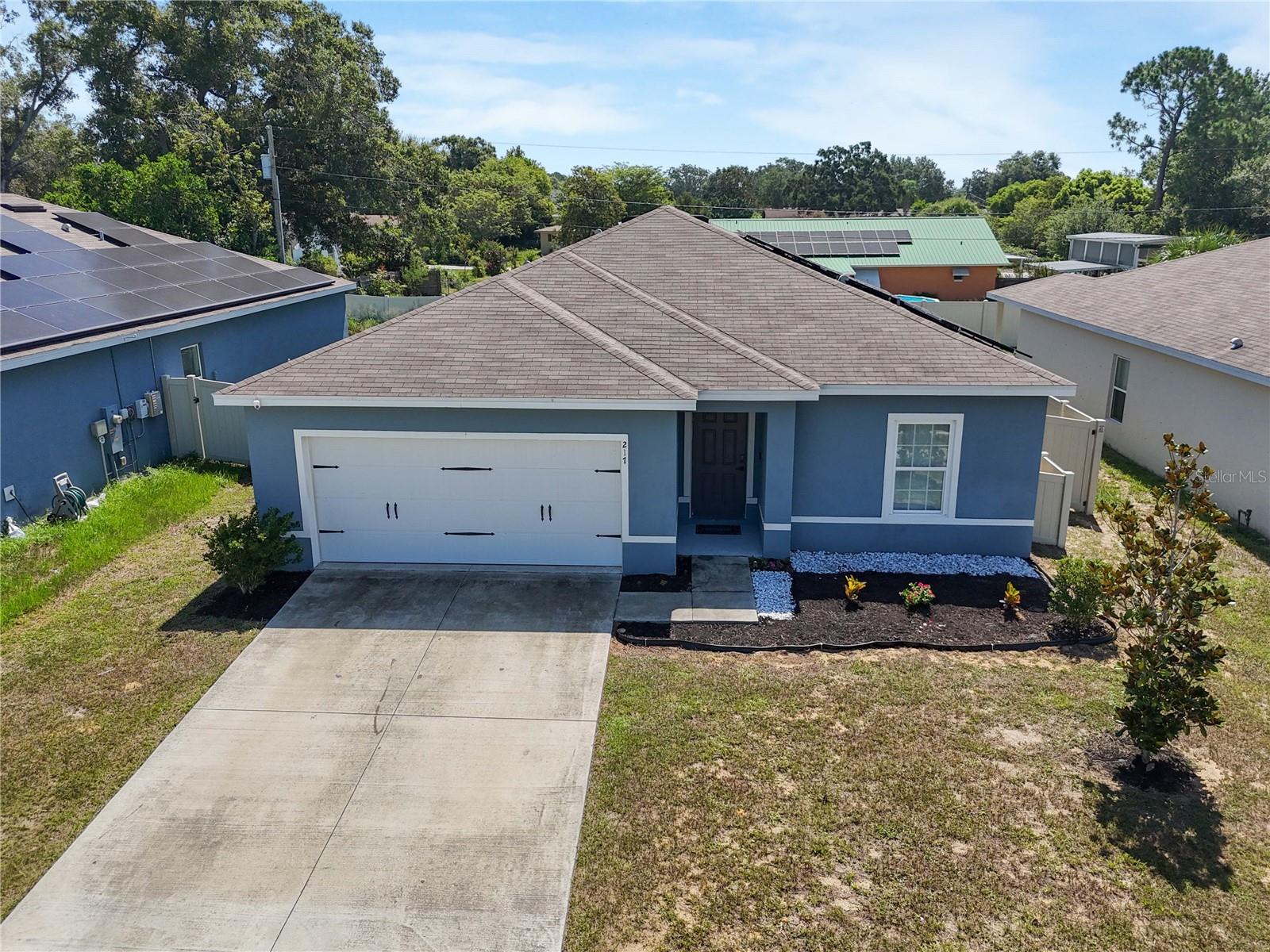 This beautiful 4 bedroom, 2 bath home is filled with natural light and features a desirable split floor plan with an open-concept layout. The home is energy-efficient with solar panels and includes smart home technology for added convenience. It showcases laminate flooring throughout the main living areas and bedrooms, with ceramic tile in the bathrooms. The kitchen boasts granite countertops, stainless steel appliances, and ample cabinetry. Enjoy the outdoors in your large fenced backyard, complete with a covered lanai perfect for relaxing or entertaining. Conveniently located near shopping, dining, and Central Florida’s top attractions such as Disney, Universal, SeaWorld, and Legoland, this home offers both comfort and an unbeatable location.