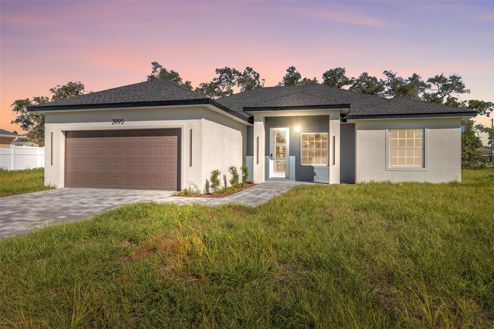 Welcome to 3995 SW 134th St, a charming Ocala residence in the heart of Marion Oaks, offering modern comfort and timeless design. This inviting single-level home showcases a bright open floor plan with seamless flow between the living, dining, and kitchen areas—perfect for everyday living and entertaining. The kitchen features generous counter space, contemporary cabinetry, and stainless-steel appliances. The primary suite offers a spacious walk-in closet and private bath, while two additional bedrooms provide flexibility for guests or a home office. Enjoy the tranquility of a fenced backyard ready for gatherings or future enhancements. Conveniently located near Marion Oaks Community Center, 1.0 mi to Winn-Dixie, 1.4 mi to Marion Oaks Elementary, and 2.2 mi to Walgreens, with easy access to I-75, shopping, and dining.