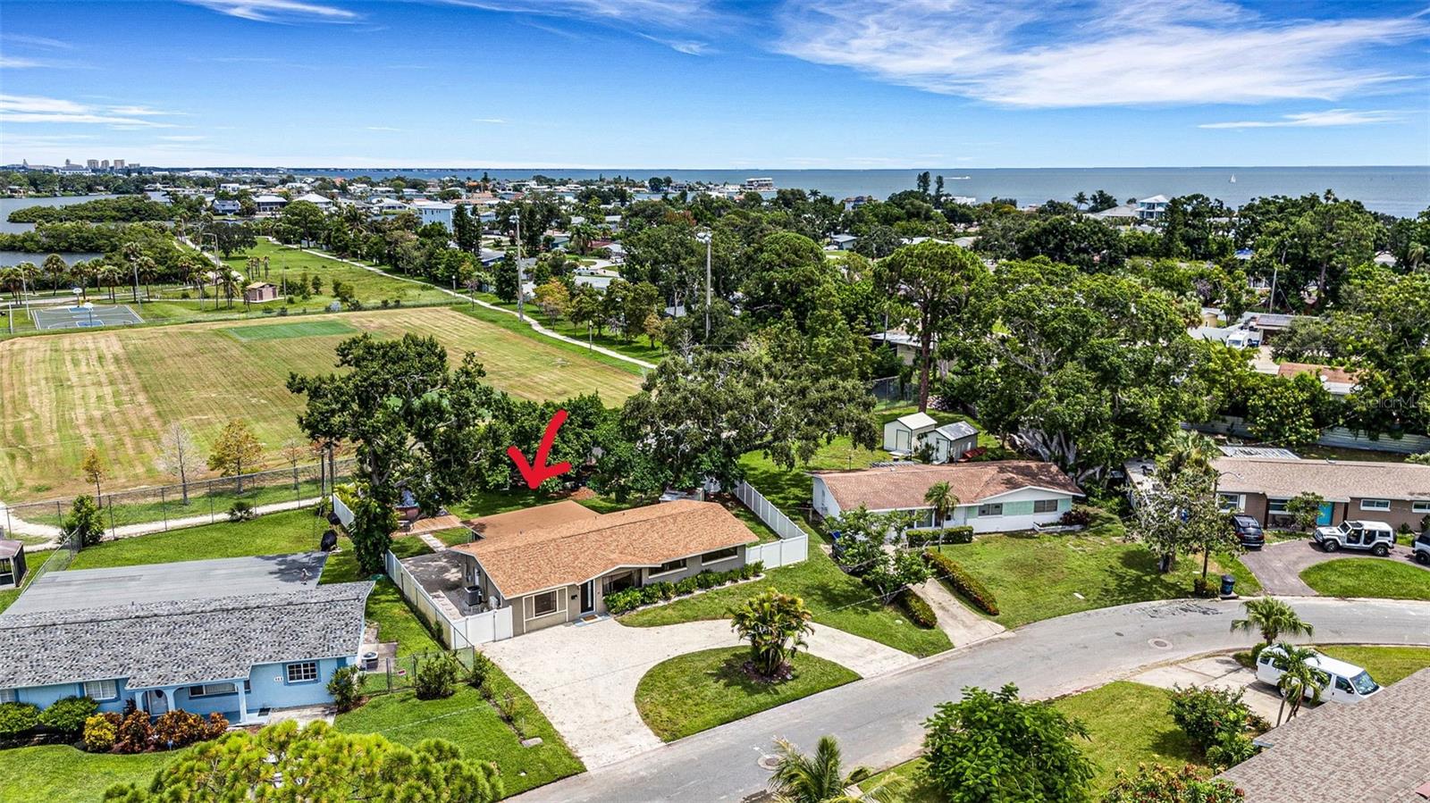 Escape to your island oasis on Coquina Key, where laid-back living meets the vibrant heart of St. Petersburg. This meticulously maintained 4-bedroom, 2-bath home has been recently remodeled to perfection. The stunning chef's kitchen features quartz countertops, double ovens, a beautiful backsplash, and high-end fixtures, along with ample storage and a dedicated coffee bar area complete with a beverage cooler.
The oversized primary bedroom boasts a built-in fireplace and generous closet space, while the large laundry room and beautifully appointed bathrooms provide both convenience and luxury. Enjoy spacious living areas that overlook a tranquil landscaped backyard, fully fenced for privacy and backing up to an incredible park. Here, you'll find tennis and pickleball courts, basketball courts, two soccer fields, two dog parks, and a scenic waterfront walking trail. Outside, an eco-friendly circular driveway welcomes you with gorgeous landscaping, setting the tone for the serene surroundings. Just three miles from downtown St. Pete, venture over the charming bridge to discover two cozy coffee shops, excellent restaurants, and a new local hotspot where you can connect with island residents—there’s even a sandwich named after the island! Plus, a 24-hour convenience store is nearby for those late-night cravings. Coquina Key Island, known as the friendly island, lives up to its name with a true sense of community. Neighbors wave hello as they stroll by or cruise past in golf carts, and residents gather for planned events like movies in the park and the beloved annual Christmas parade. All of this, with easy access to some of the most beautiful beaches in the area.