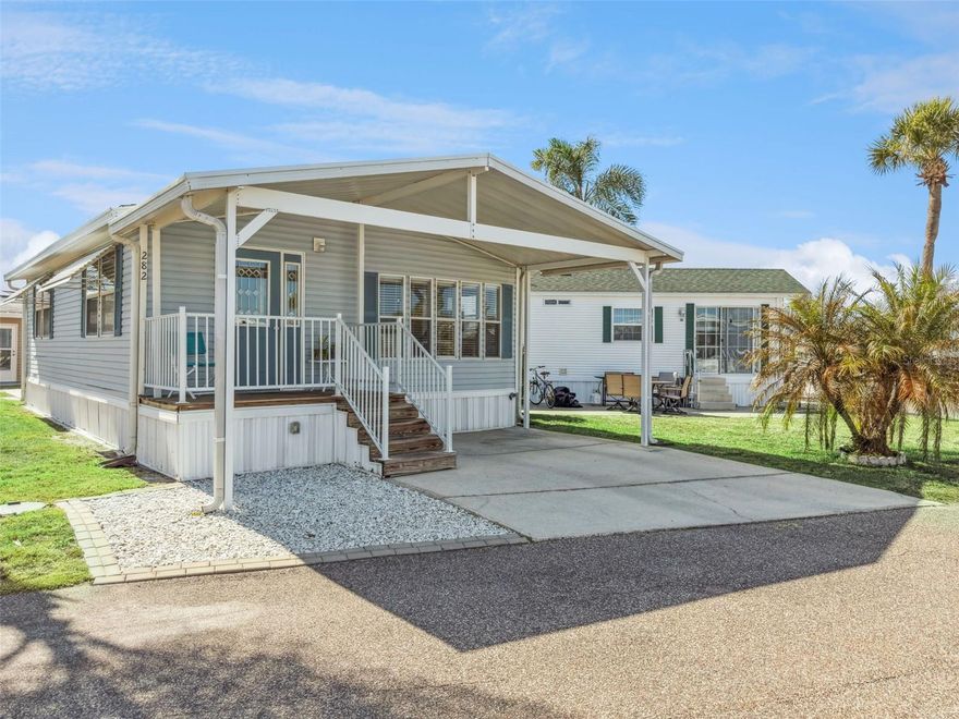 A beautifully updated 2-bedroom, 1-bathroom manufactured home in a guard-gated, lakefront, resort-style 55+ community—designed for easy living, flexibility, and low maintenance. Located on Lot 282 at 9000 US Highway 192, this light-filled home makes excellent use of space with smart built-ins and thoughtful updates throughout. The kitchen is both stylish and practical, featuring granite countertops, a breakfast bar, ample cabinetry, and an added pantry closet. Just off the kitchen is a sun-drenched dining area, currently being used as a home office, offering flexible space that adapts easily to your needs. The kitchen and dining area open into a spacious, oversized living room with a bright, open layout that comfortably accommodates both everyday living and entertaining. A built-in Murphy bed provides a practical solution for overnight guests without sacrificing usable space, making the room exceptionally versatile. Laminate wood flooring runs throughout the main living areas, enhancing the home’s cohesive and airy feel. The primary bedroom includes built-in closets for efficient storage, while the second bedroom is a petite, flexible space that also houses the washer and dryer, ideal for owners who value convenience and simplicity. Outdoor spaces are just as well considered. Enjoy a covered front porch, a front driveway with carport, and a dedicated golf cart parking area, along with a small back patio perfect for quiet mornings or relaxed evenings. Recent care includes professional AC vent cleaning by Stanley Steemer and a fresh pressure wash, adding to the home’s move-in-ready appeal. Recent improvements include a roof replacement approximately three years ago, along with replacement of the air conditioning system and water heater within the past few years. These updates provide added confidence and reduce near-term maintenance concerns. This home is located within the guard-gated Outdoor Resorts of Orlando, where ownership includes an active, social lifestyle and land ownership with no lot rent. Amenities extend well beyond the basics and include a 9-hole par-3 golf course, mini golf, two swimming pools, lighted tennis and pickleball courts, bocce ball courts, shuffleboard, and a private boat ramp and marina with access to Lake Davenport. Residents also enjoy a full calendar of organized activities such as water exercise classes, walking clubs, coffee clubs, shuffleboard meetups, bingo, card games, crafting clubs, and community gatherings like Super Bowl potlucks, creating countless opportunities to stay active and connected. Community dues include water, trash, and basic cable, and rentals are permitted, offering flexibility when the home is not in use. Whether you’re seeking a low-maintenance full-time residence, a seasonal retreat, or a property that blends comfort with an engaging, amenity-rich lifestyle, this home delivers thoughtful updates within a secure and welcoming Central Florida setting.