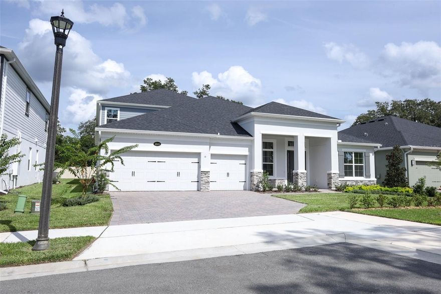One or more photo(s) has been virtually staged. Welcome to Francisco Park, an intimate enclave community in the heart of Oviedo featuring winding streets, manicured landscaping, and undeniable curb appeal. Nestled at 2531 Blue Wave Place, this brand-new Brookhaven with Bonus Room and Rear Balcony, crafted by MI Homes, blends timeless design, modern comfort, and an unbeatable location within top-rated Seminole County schools.

The elegant front exterior showcases a three-car garage, pavered driveway, and a stately covered entry framed with stone accents—setting the tone for the craftsmanship found within. Step inside to a bright, open layout where soaring ceilings, designer finishes, and wide-plank flooring flow seamlessly throughout.

At the heart of the home, the gourmet kitchen boasts sleek white cabinetry, stainless steel built-in appliances, quartz countertops, an expansive island with seating, and a walk-in pantry—perfect for both family living and entertaining. The kitchen opens to the spacious living and dining areas, filled with natural light and direct access to the enclosed patio.

The primary suite is a private retreat, offering a spa-inspired bathroom with dual vanities, walk-in shower, soaking tub, and oversized walk-in closets. Additional bedrooms and baths are thoughtfully positioned for comfort and flexibility, while the upstairs includes a bedroom, bathroom, and bonus room with rear balcony expanding your living space—ideal as a game room, media space, or guest retreat.

Step outside to enjoy the lanai and backyard, with ample room for outdoor living, gardening, or future pool plans.

Francisco Park places you minutes from everything that makes Oviedo exceptional: Oviedo on the Park, boutique shopping, dining, and medical facilities, with easy access to major employment centers via 417 and 434. Outdoor enthusiasts will love nearby trails and parks.

This is more than a home—it’s a lifestyle. Schedule your private tour of 2531 Blue Wave Place today and discover why the Brookhaven is one of MI Homes’ most sought-after designs.
