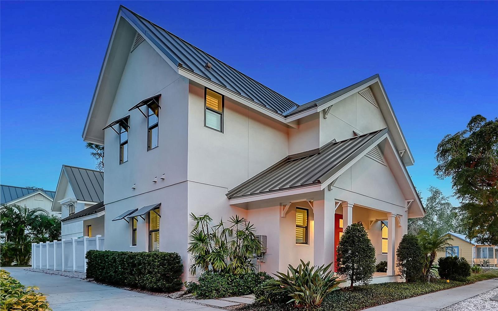 Live-work-play in downtown Sarasota’s historic Laurel Park with income potential from the studio apartment over the garage. This feel-like-new 2018 coastal modern residence is close to everything that makes Sarasota one of the best places to live and visit such as the bayfront, beaches, airport, marina, dining, shopping and the arts. The smooth stucco exterior, corbel details, travertine hardscape and shiplap wood accents are complemented by high ceilings, wide-plank hardwood floors, impact glass and designer finishes. Create your urban oasis inside the flexible 2,798-square-foot floor plan. At the heart of the home is an open kitchen/great room space anchored by a substantial island where the cook is front-and-center, surrounded by solid-wood cabinetry, quartz countertops, stainless farmhouse sink and gas cooktop with downdraft ventilation. The great room features a peaked ceiling and flows into a screened-in covered lanai. The owner’s suite on the first floor includes dual walk-in closets, en-suite bath with free-standing bathtub and walk-in shower, and access door to the pool area. The rest of the bedrooms are upstairs along with a bonus room. The studio apartment over the garage offers varied opportunities. It can be an in-law suite, a home office, an apartment or a vacation rental. The space includes a main room with convenience alcove and full bath. The alfresco courtyard between the main residence and the garage has a swimming pool, travertine deck with outdoor seating area and outdoor kitchen with built-in Coyote gas grill under a wood pergola. Historic Laurel Park is a wonderful walkable neighborhood within one mile of two grocery stores, Bayfront Park, Sarasota Recreational Trail, city marina, Farmers Market, shopping, dining and a variety of yoga/fitness studios. Come explore the lifestyle possibilities in this downtown Sarasota gem.