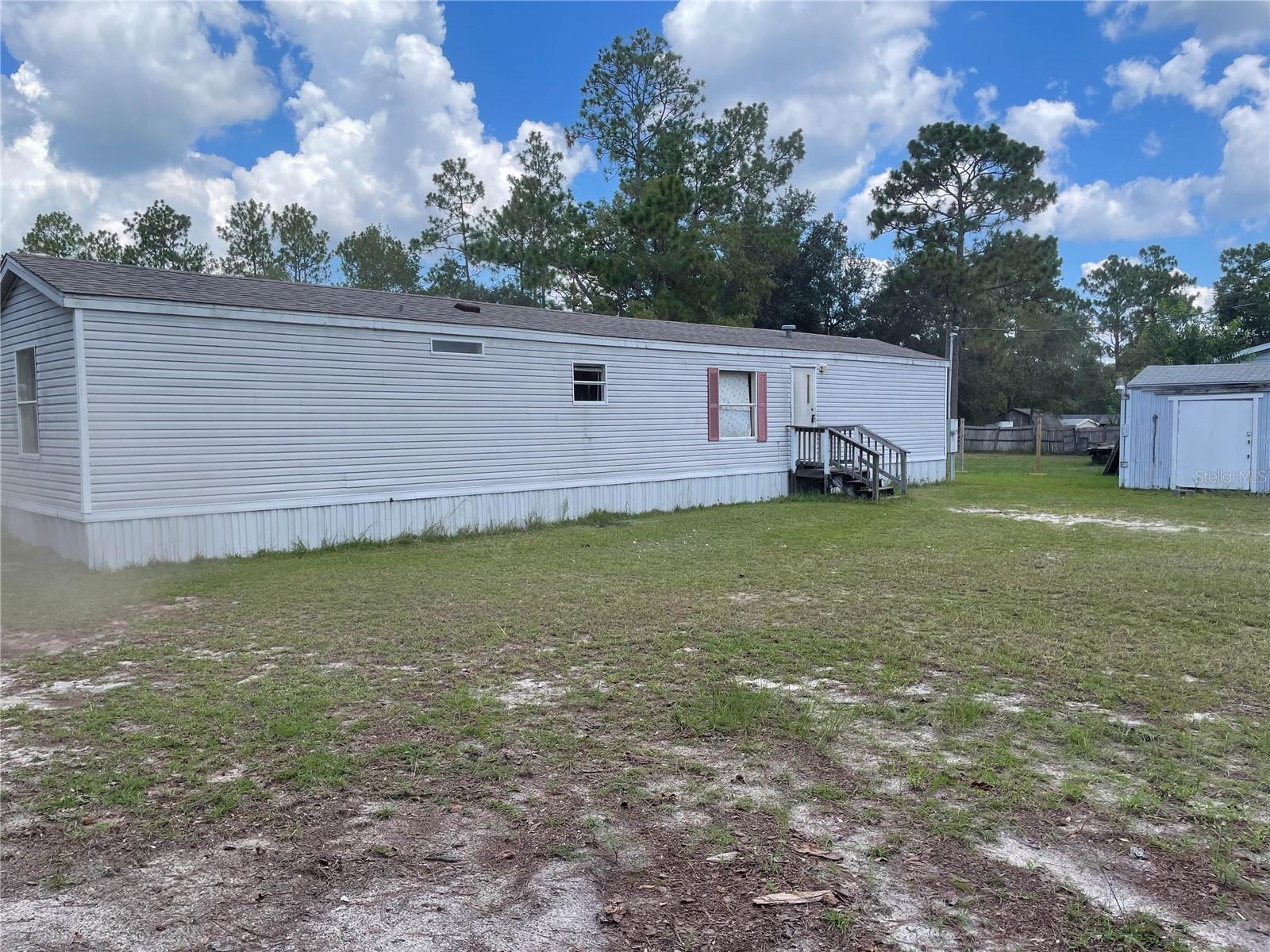 This is the perfect canvas located just 15 minutes from the World Equestrian Center and just 10 minutes from the Rainbow River Spring Head in Marion County. This home features a brand new roof in 2022 with individual shingles for added durability and completely rebuilt A/C system with new compressor and circulation panel. Horse friendly location zoned AG, close to the beautiful town of Dunnellon, which offers the charm of the old countryside and is ideal for enjoying the outdoors. The 1998 mobile is currently occupied and ready for the new owner to make repairs or drag something new onto the lot. This is the chance to escape the hustle and bustle of city life and build the beautiful home of your dreams.