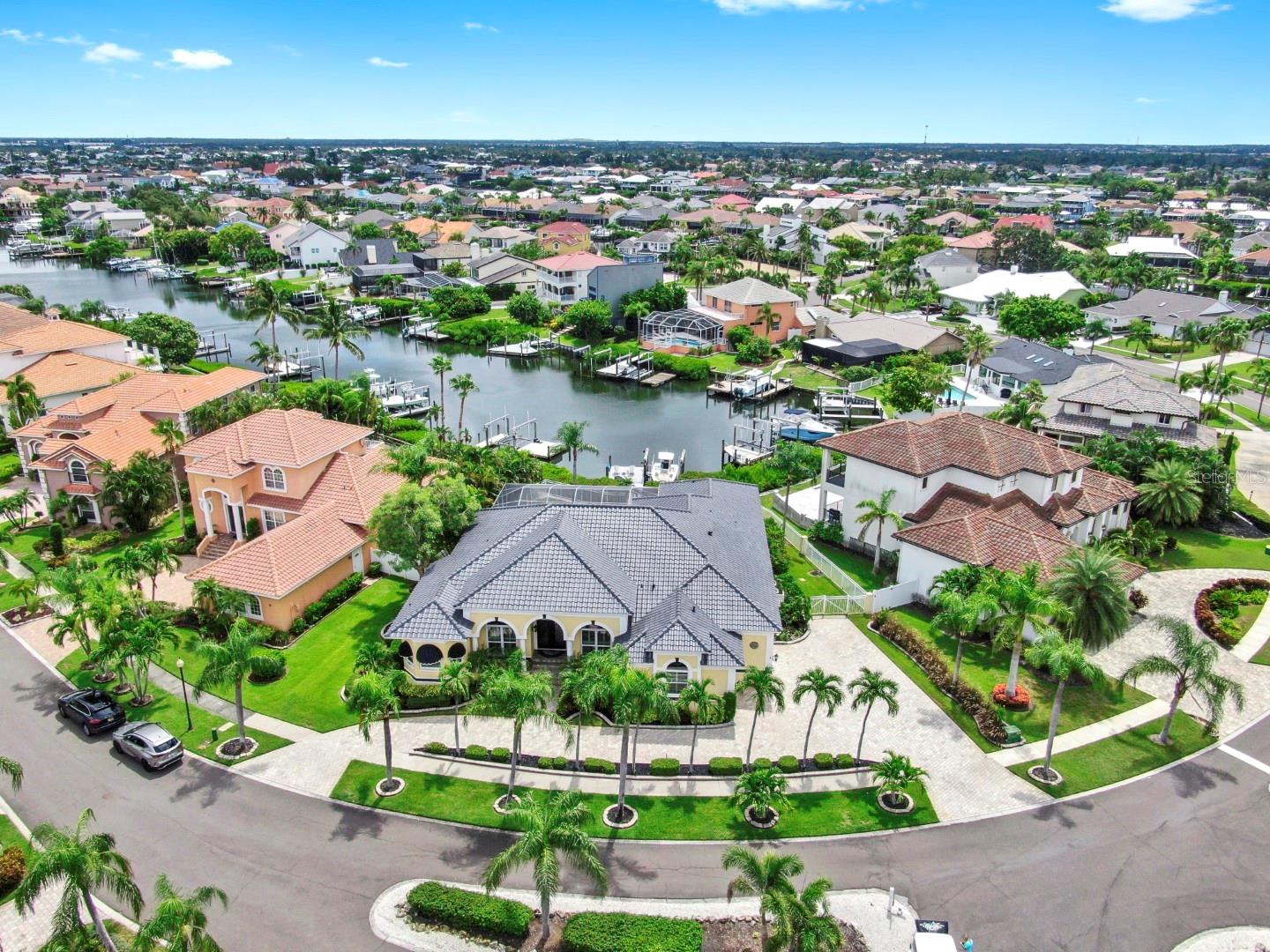 Experience the epitome of luxurious waterfront living in this elegant Spanish-Mediterranean residence, boasting a grand circular driveway and coveted canal-front access.
From the moment you arrive, you're greeted by lush landscaping framed by over 19 tall palms. Step through brand-new double doors into a refined formal living and dining space, featuring marble floor accents and serene pool oasis views. A custom-built wet bar and abundant formal seating set the tone for sophisticated entertaining.
The gourmet kitchen is a culinary masterpiece, opening to a spacious family room with a gas fireplace. It showcases custom cabinetry, brand-new quartz countertops, a large island, stainless steel appliances, wall-mounted oven, gas cooktop, and a premier reverse osmosis water filtration system. A walk-in pantry and breakfast nook offer canal and pool views, while the windows flood the home with natural light. High ceilings, crown molding, plantation shutters, and tile throughout create a cohesive, luxurious atmosphere, complemented by a comprehensive in-home and outdoor surround-sound system.
Retreat to the master suite, which opens directly to the pool area and features expansive walk-in closets and a spa-inspired bath. Revel in travertine walls, custom cabinetry with dual vessel sinks, a granite-topped vanity, a clawfoot bathtub, a separate shower, bay windows, and exquisite lighting. The split-bedroom floor plan ensures privacy, with three additional bedrooms and baths on the opposite wing, all finished with custom cabinetry, travertine details, and stylish vessel sinks.
Key updates include a new roof (2025), all new windows in the front of the house, a recently upgraded water heater, and a seawall with vinyl sheet piling and a reinforced concrete cap designed for 30+ years of life. Outside, enjoy a heated saltwater pool with LED multi-color lighting, self-cleaning equipment, and a spa set within a gorgeous paver patio. The brand-new dock rebuilt in 2024 accommodates a 10,000 lb. boat lift, inviting effortless seafaring adventures.
A dream location, in just five minutes you're in the open bay, perfect for boating, kayaking, dolphin watching, and fishing. This home sits in Symphony Isles, a gated community offering 24-hour manned security, a private beach with a gazebo, beach volleyball, a community pool, a boat ramp, playground, and a vibrant recreational building for celebrations.
Fun fact; this remarkable home was once owned by Nick Carter of the Backstreet Boys, adding a touch of Hollywood provenance to an already exceptional property. Call to schedule your private tour today and experience the luxury of waterfront living at its finest.