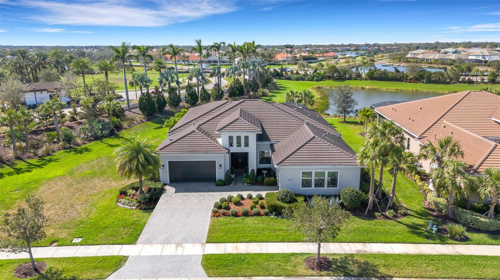 Stay High and Dry from Hurricanes with this private, west facing, oversized corner lot which defines this stunning home beyond the gates of the hidden enclave of Artistry. This gorgeous 3 Bedroom, 3 full bath with Bonus room home will captivate your attention with its stunning open concept living area and meticulous craftmanship. When you first enter this home, the large entry way and high ceilings define a space fit for all of your entertainment needs. Light pours into this large chef’s kitchen which features gourmet gas cook top, convection/oven combination with hood, stunning quartz countertops and upgraded cabinetry. There’s also a special designated area for a bar or coffee station with extra cabinetry. The master suite is a relaxing oasis with large soaking tub, double quartz sinks and large walk in closet. This home features a three car garage and a large, private lanai with heated pool and amazing sunsets and nature views! No neighbors in sight! There are no CDD fees in this maintenance free community. Low Hoa dues include a large, community zero-entry pool, club rooms, fitness center, playground, sports courts, and plenty of trails for hiking/biking. Access to many golf courses, Rothenbach park, Celery fields all within a 2 mile radius and also plenty of shopping, restaurants, SRQ airport and world class beaches just a short drive. Motivated Seller! Come and make an offer!