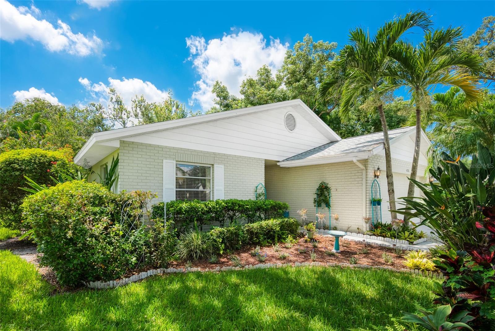 This spacious and lovingly maintained single family style home has all the conveniences of maintenance-free living as a condominium association. NEW roof 2025! Step in to a charming atmosphere; 3 bedrooms (2 are en-suite), 2 1/2 baths, patio-style home with attached 2 car garage, a tropical Florida room which easily accesses a relaxing backyard sitting garden zen like area full of flowers the seller has planted. Cathedral ceilings accentuate the spaciousness of the living and dining areas. Curb appeal galore in Pinehurst's tropical setting of matured trees and beautifully maintained yards. Pinehurst is an established peaceful and quaint community with a heated pool, tennis court (can be used for pickle ball) and clubhouse for your enjoyment. Centrally located in Sarasota and close to Sarasota Airport (SRQ), UTC mall, downtown Sarasota and Lakewood ranch, all where shopping, dining, arts and entertainment await you! Do not miss this opportunity to make this home your own.
