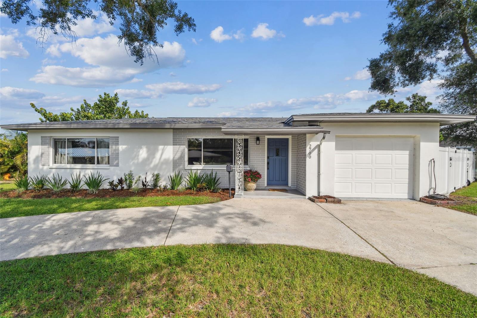 Welcome to this beautifully updated 3-bedroom, 2-bath home with a 1-car garage and bonus room, nestled on an oversized .21-acre corner lot in sunny St. Pete! Enjoy ample front and backyard space, perfect for both relaxing and entertaining. The fully fenced backyard features a new paver patio (2025) and even has a roller gate—perfect for pulling in a boat or trailer directly into your yard! Inside, the home was thoughtfully updated in 2023, featuring a brand-new kitchen, updated switches, and recessed lighting throughout. The open-concept layout allows the kitchen and living room to flow seamlessly, with a stylish bar top that connects the spaces—perfect for casual dining or chatting with guests while cooking. The kitchen is a showstopper, complete with stainless steel appliances, quartz countertops, solid wood cabinets, a white granite composite sink, and a designer faucet. Natural light fills the home from both directions—start your mornings with a coffee on the charming front porch and end your day watching the sunset from the back patio. The split floor plan offers privacy, with a primary suite that includes an ensuite bath. A bonus room provides extra flexibility—it can serve as a 4th bedroom, office, or storage space. Additional upgrades include new ductwork (2023), new insulation (2024), and fresh interior and exterior paint (2023). The roof and AC were replaced in 2017. Located within walking distance to Northwest Park, you'll enjoy access to public tennis courts, pickleball courts, a pool, and other community amenities. Plus, you're just 12 minutes to Downtown St. Pete and only 15 minutes to St. Pete Beach, Treasure Island, and Madeira Beach. This move-in ready home offers the perfect blend of modern updates, outdoor space, and unbeatable location. Don’t miss it!